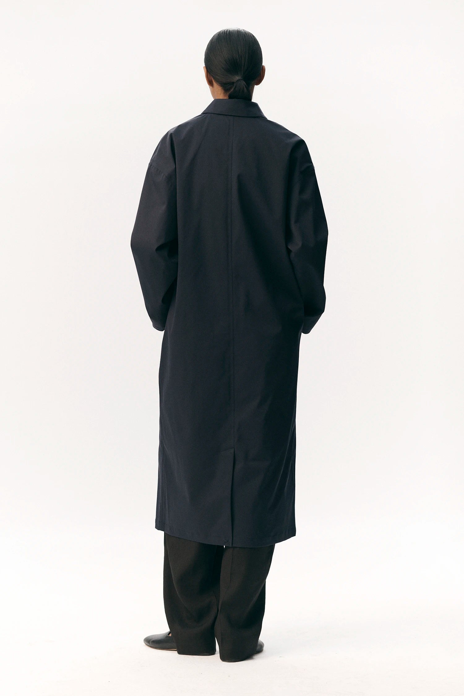 Rear view of Janice B Navy Coat showcasing its stylish design and practicality.