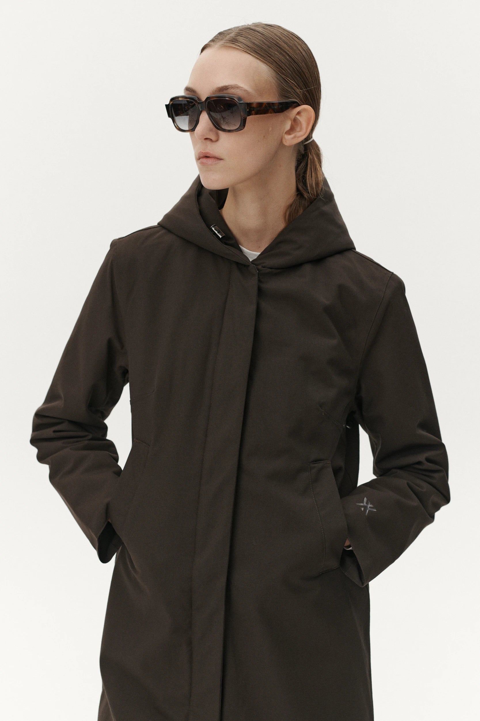 Model wearing Not So Long Tube Polyrayon Chestnut Parka, sunglasses, showcasing waterproof and breathable features.