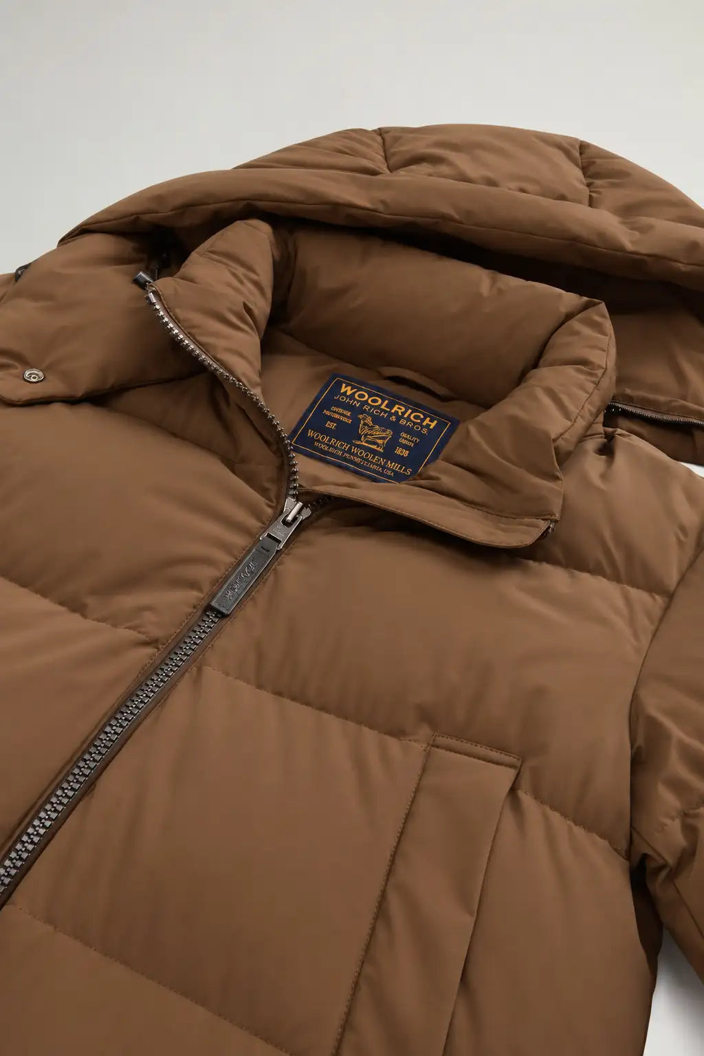 Madison Jacket Dark Earth Coat by Woolrich, showcasing premium down filling and stand-up collar.