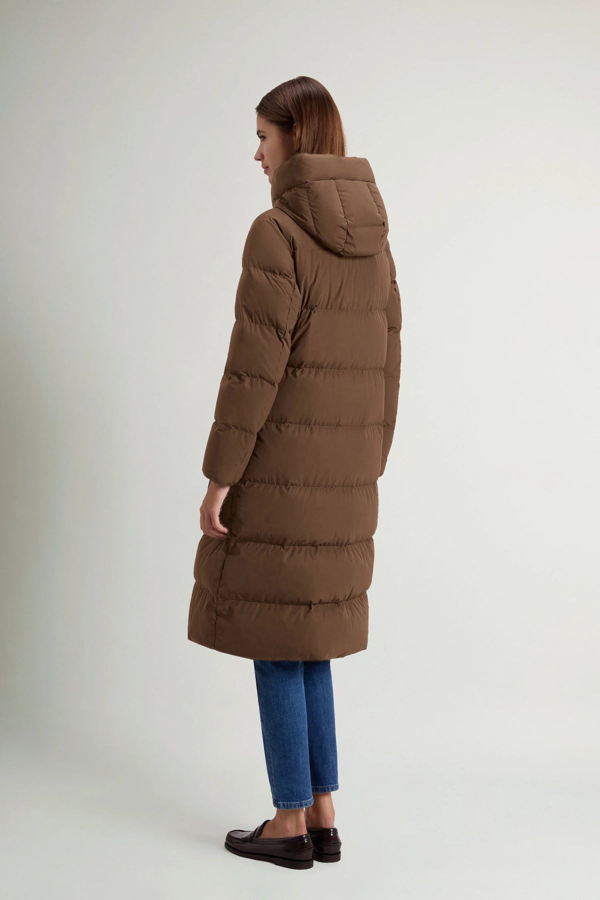 Madison Long Coat Dark Earth Coat by Woolrich shown from the back, featuring a stylish hood and puffy design.