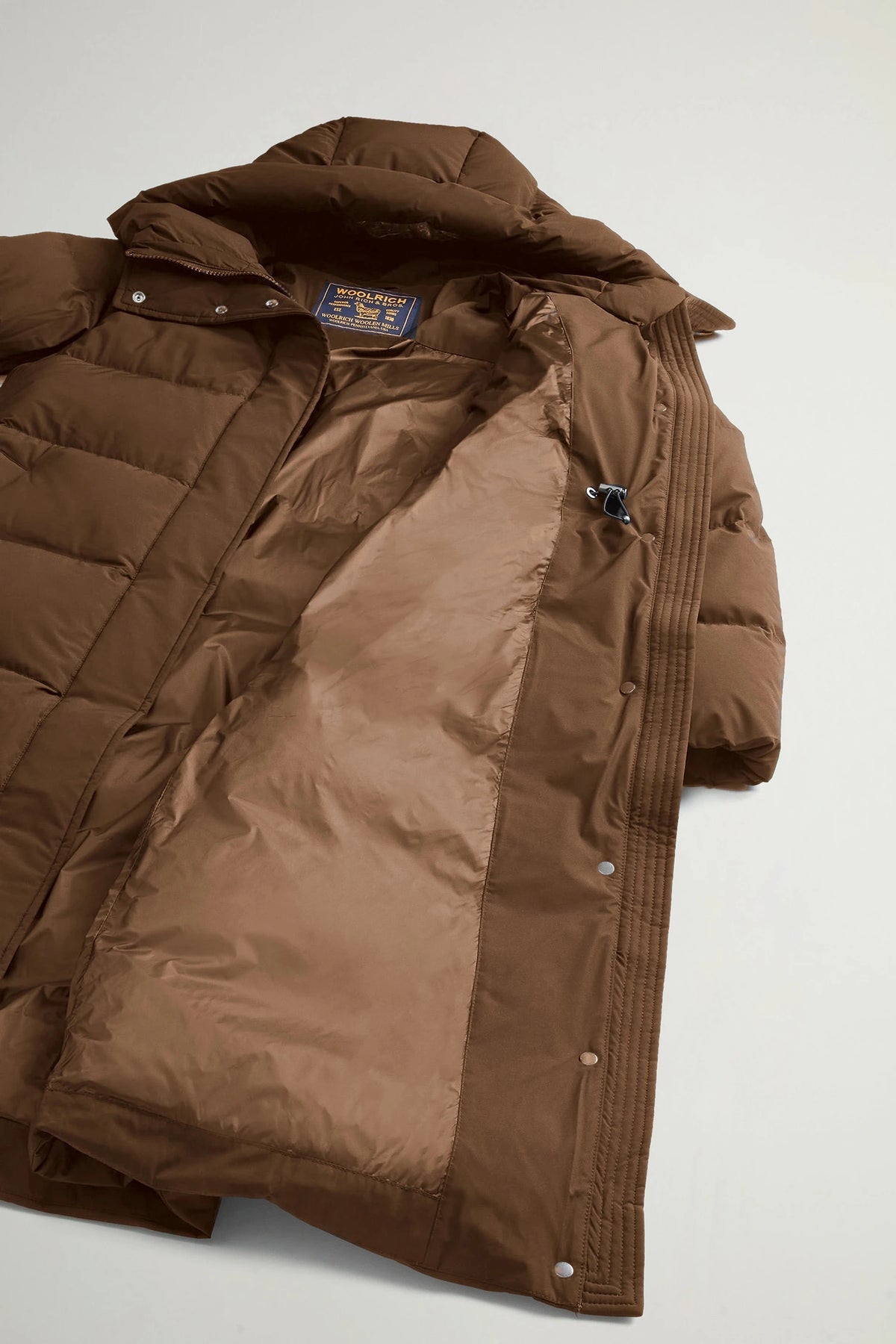 Inside view of Madison Long Coat Dark Earth Coat by Woolrich, showing premium down fill and stylish design.