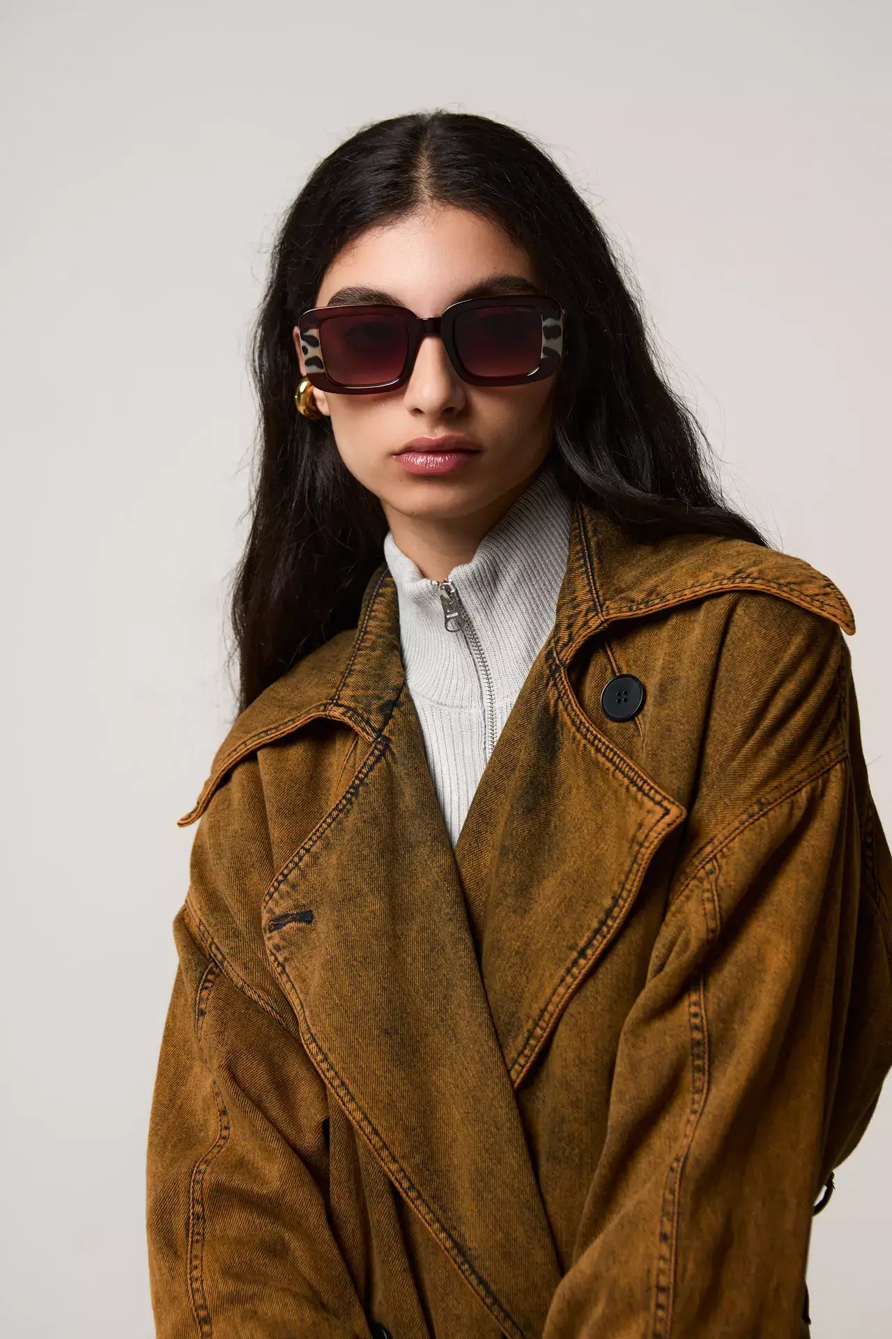 Avery Bronze Bobcoat Sunglasses worn by a model in a stylish outfit, showcasing UV protection and eco-friendly frame.