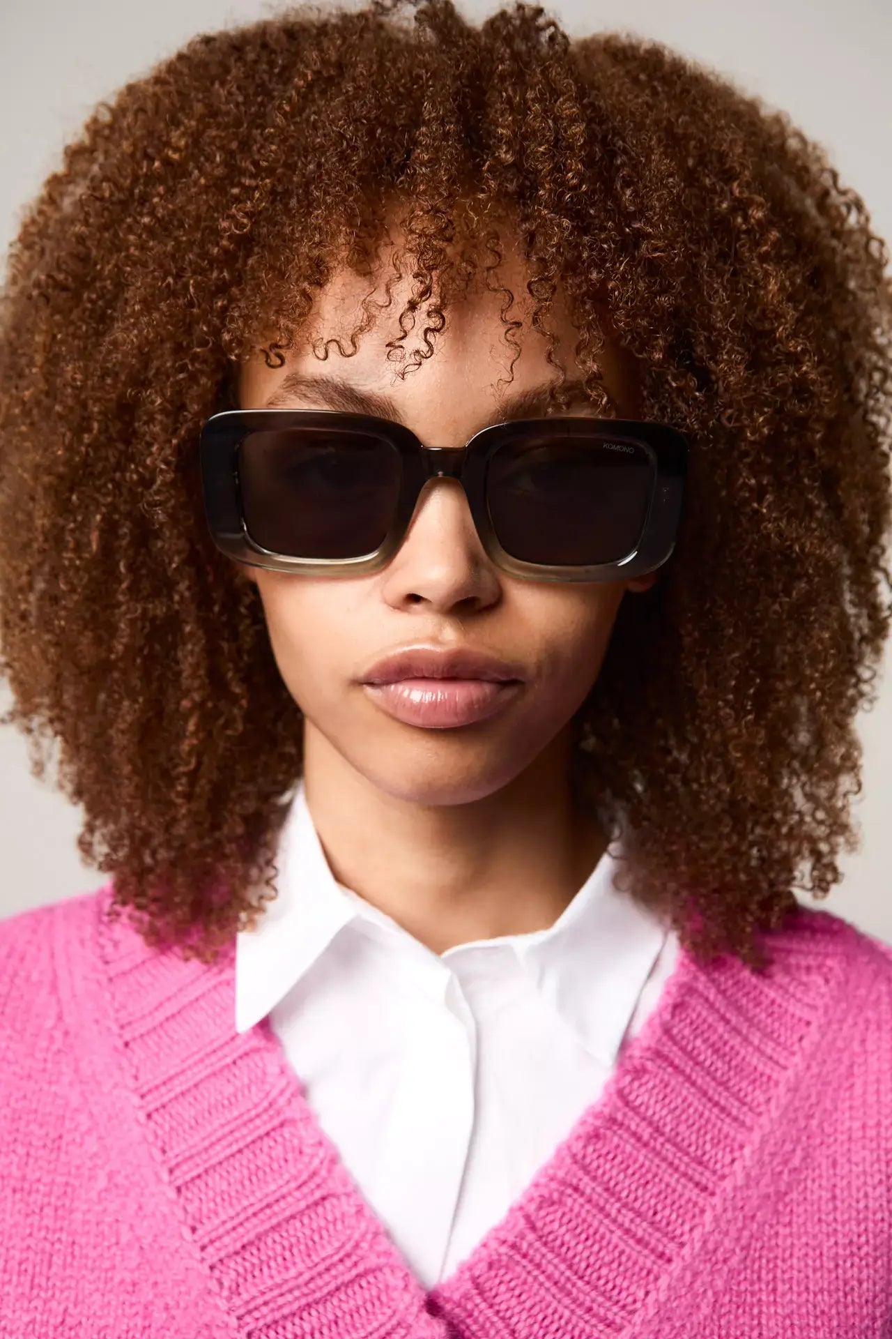 Avery Greyscale Sunglasses worn by a model with curly hair, showcasing stylish design and UV protection features.