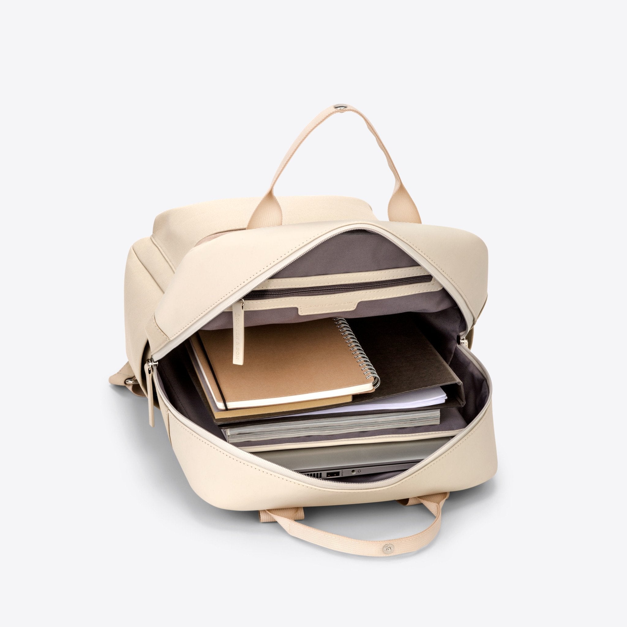 Bergen Sandstone Backpack open showing inner storage for notebooks and 13 inch laptop.