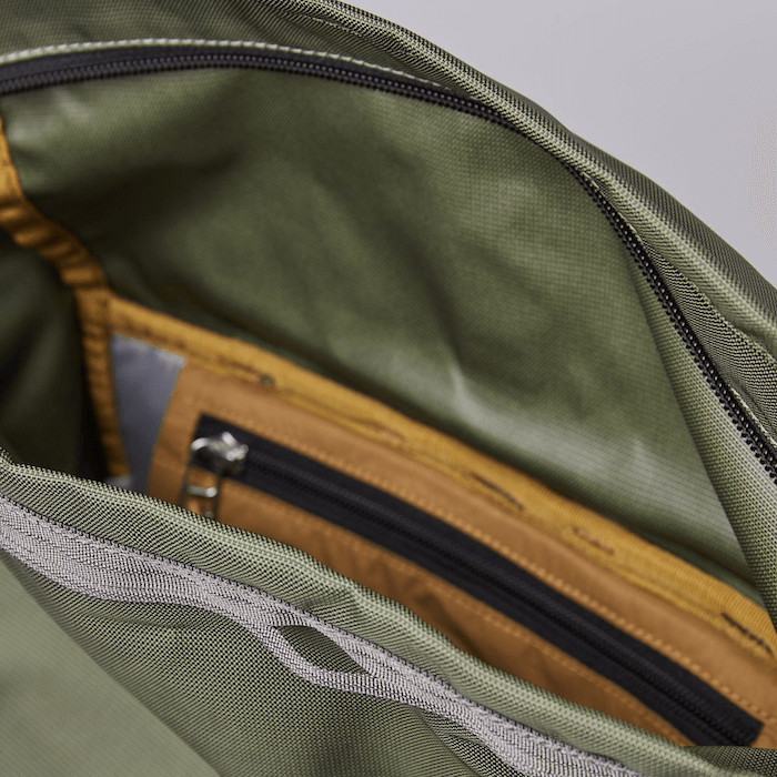 Interior view of the Forest Hike Trekk Green Backpack showcasing pockets and water-resistant features.