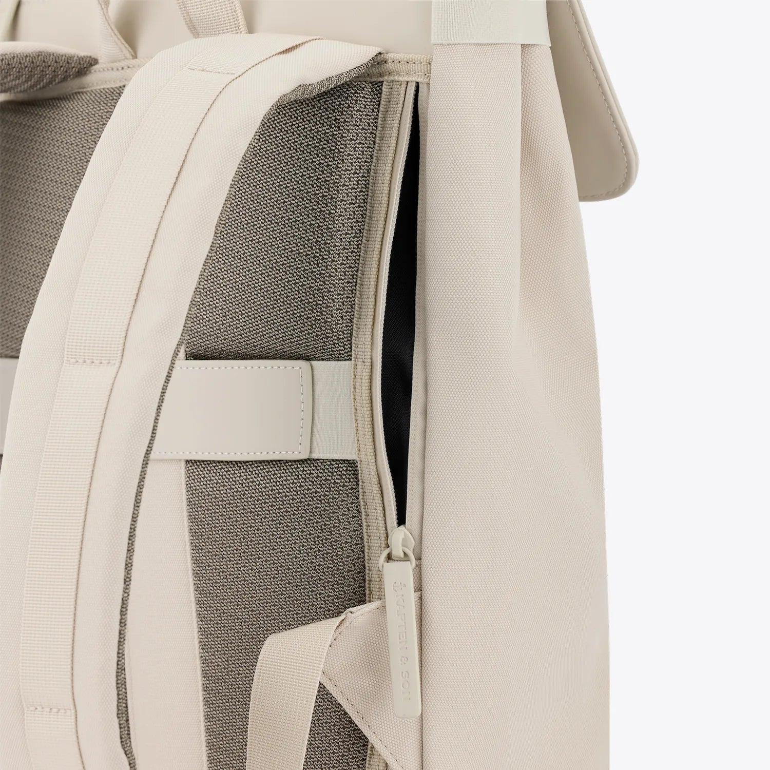 Fyn Sandstone Backpack showcasing minimalist design with outer and inner pockets.