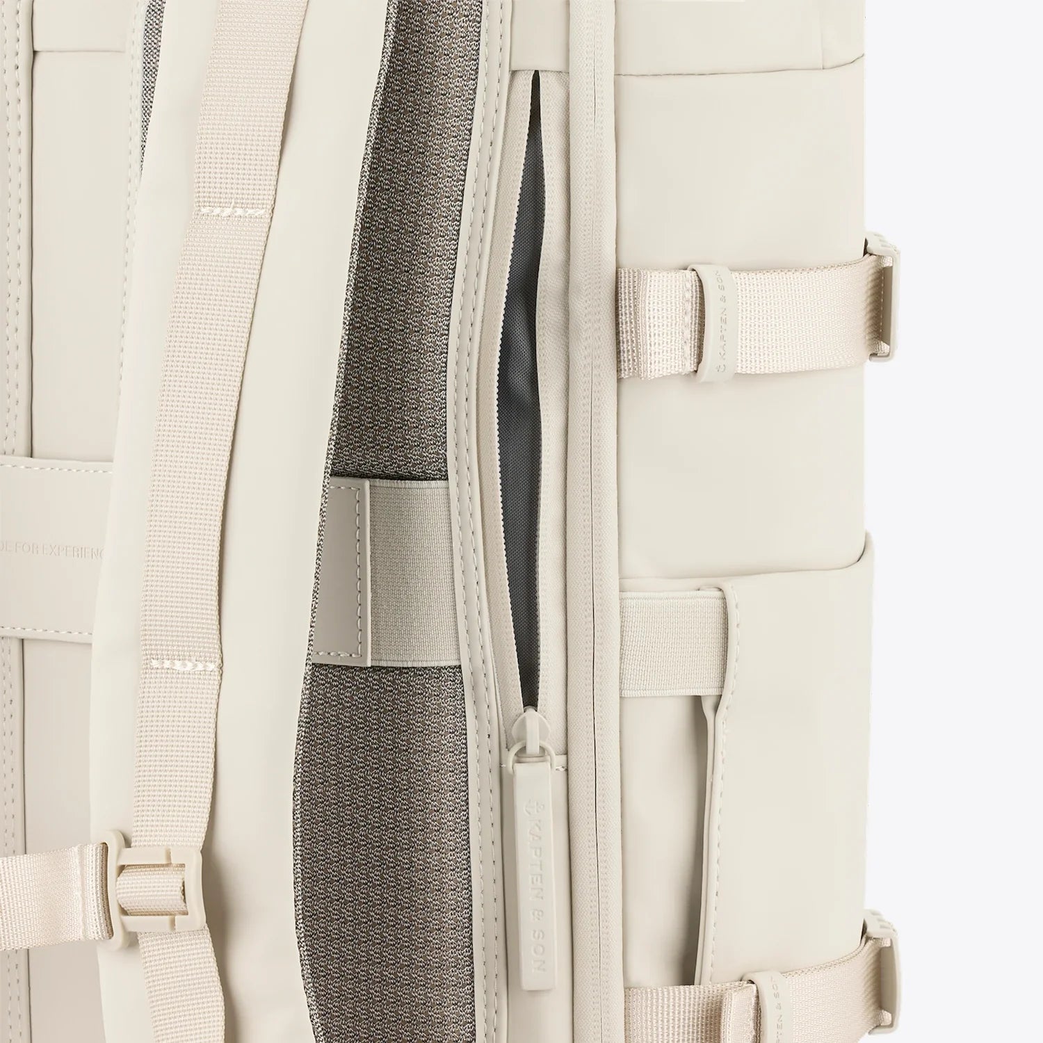 Close-up of the Helsinki Pro Sandstone Backpack showcasing the backside opening and padded shoulder straps.