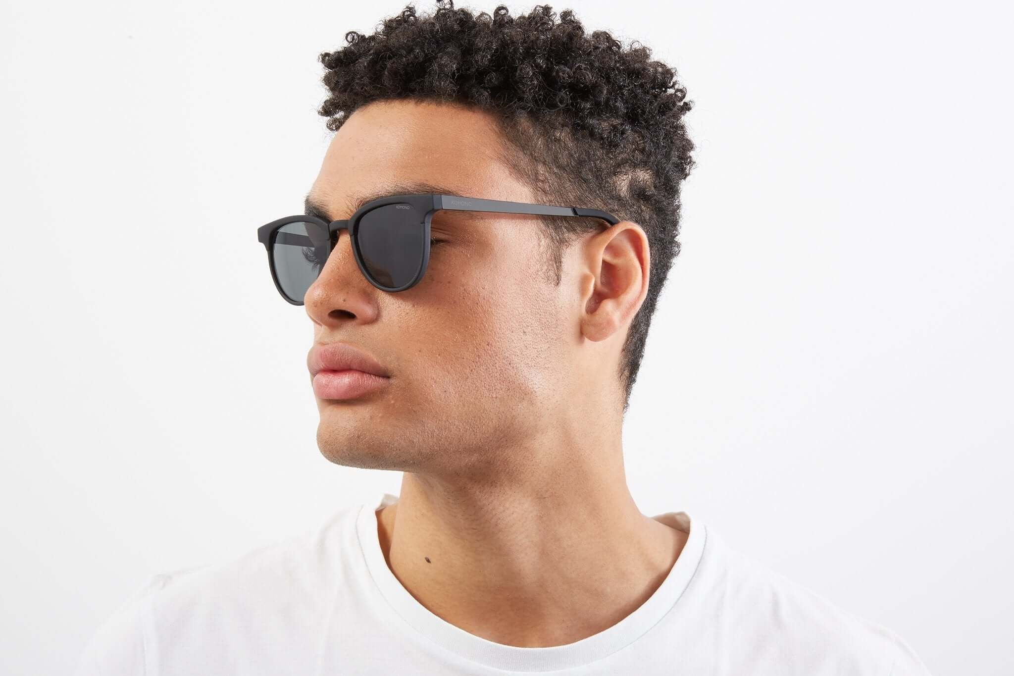 Francis Metal Black Sunglasses worn by a man with curly hair, showcasing UV protection and sleek design.