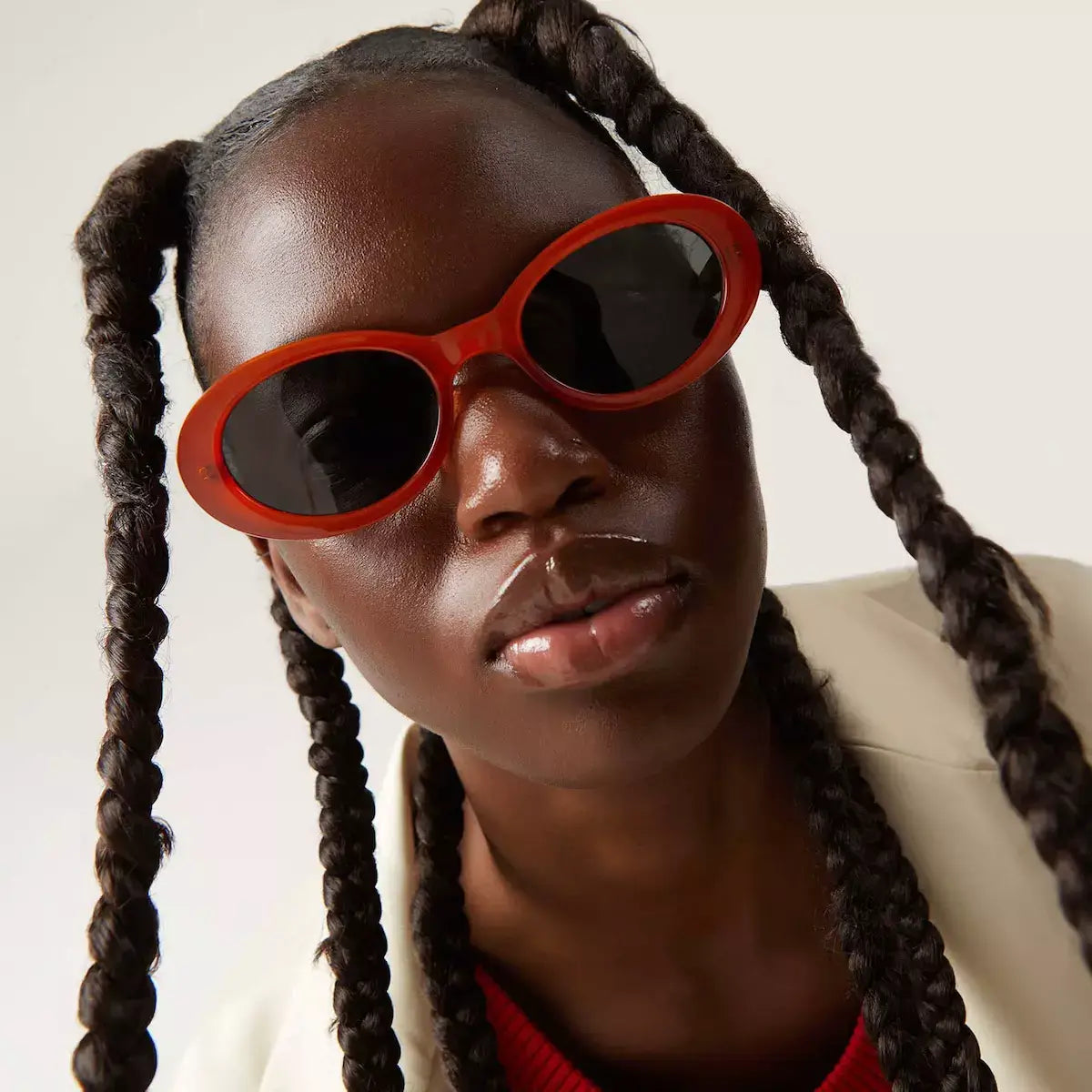 Ana Fox Sunglasses model showcasing stylish sunglasses with bold red frame and dark lenses.