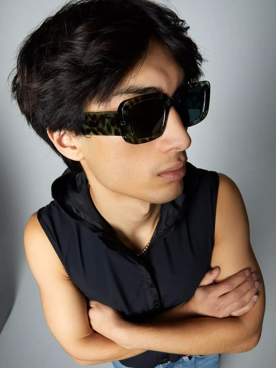 Avery Aquatic Teal Sunglasses worn by a model, showcasing dark green blue lenses and an eco-made bio nylon frame.