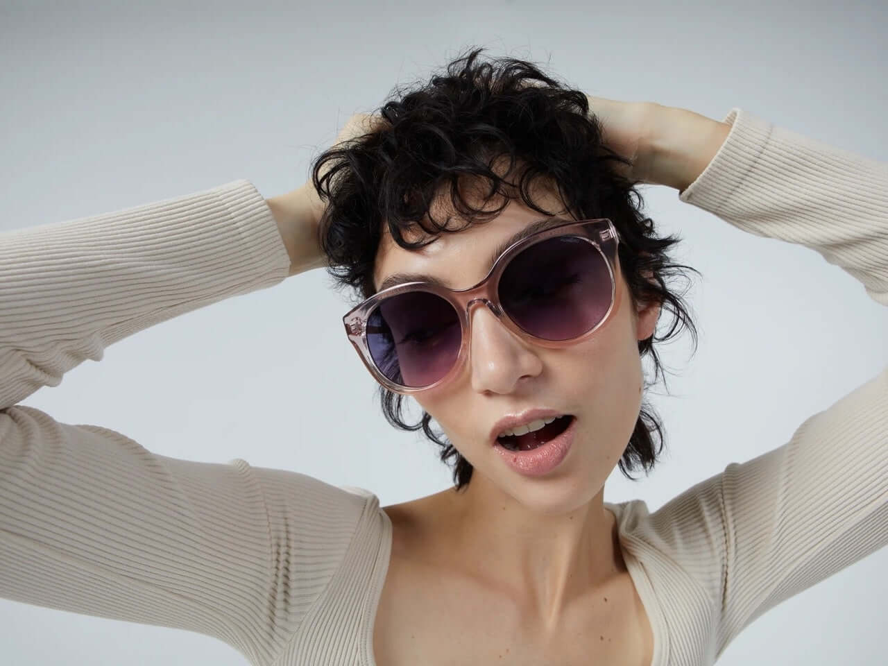 Ellis Metal Blush Rose Gold Sunglasses worn by a woman, showing UV protection and stylish design.