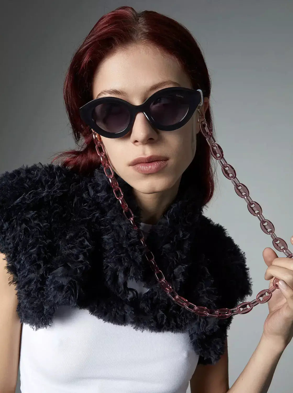 Grace Black Glossy Sunglasses worn by model with stylish attire and chain accessory.