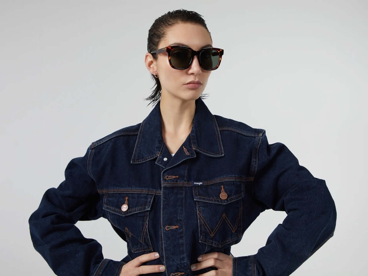 Model wearing Sienna Havana Sunglasses and denim jacket, showcasing stylish UV protection and eco-friendly design.