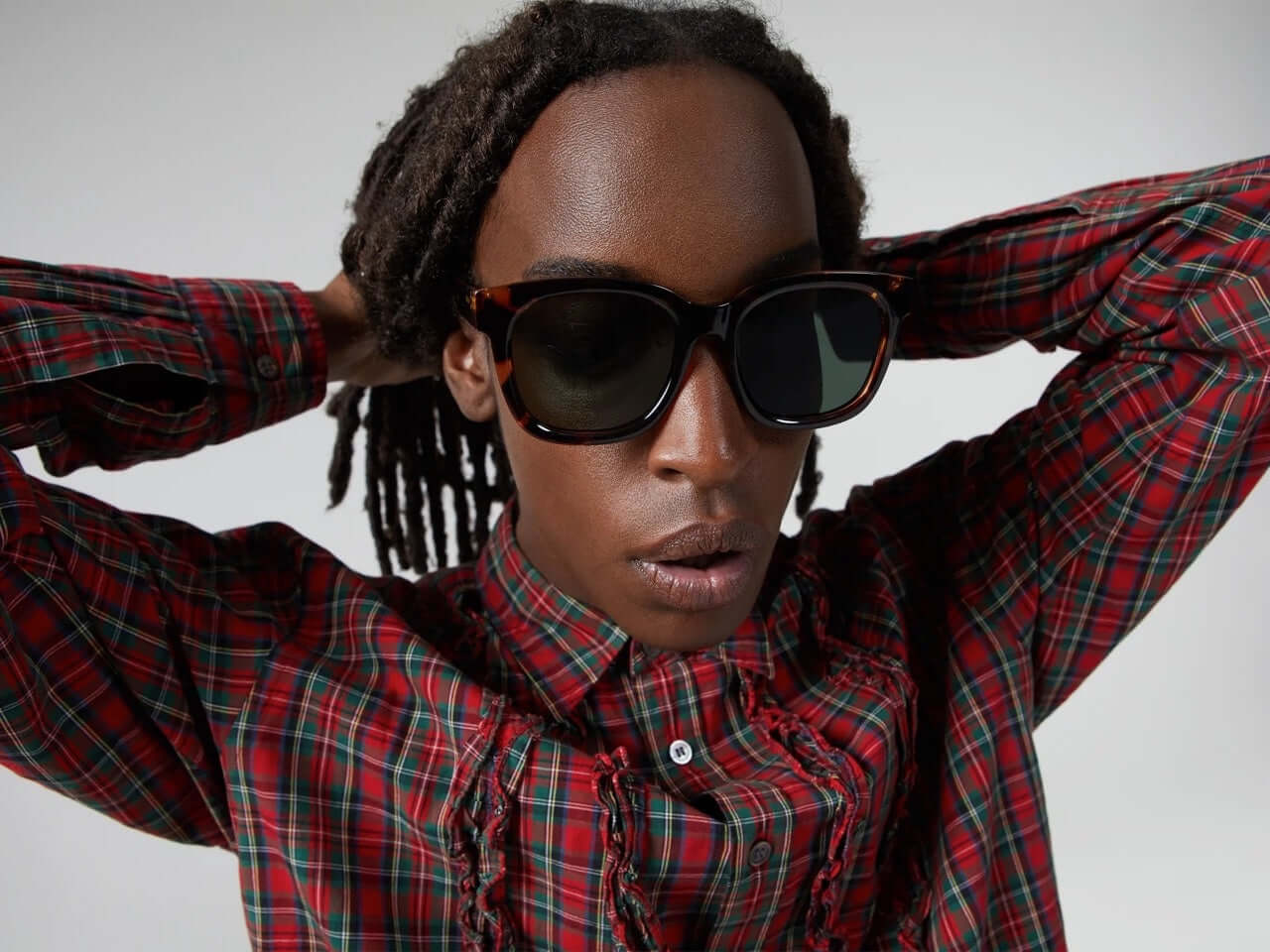 Sienna Havana Sunglasses worn by a model with long hair, showcasing dark green lenses and eco-friendly design.