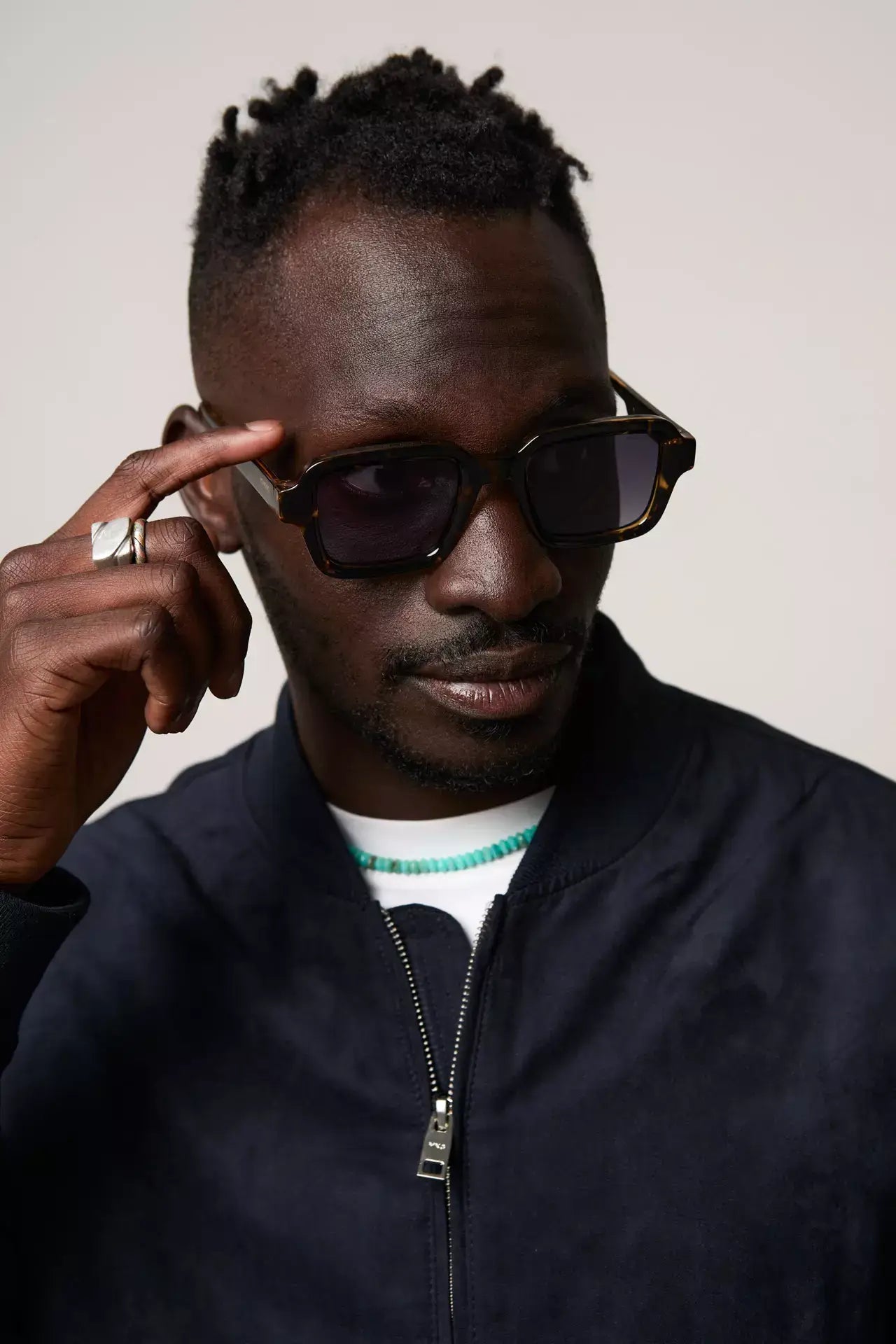 Model wearing Lionel Dark Tortoise Sunglasses with a stylish outfit, showcasing UV 400 protection and eco-friendly design.