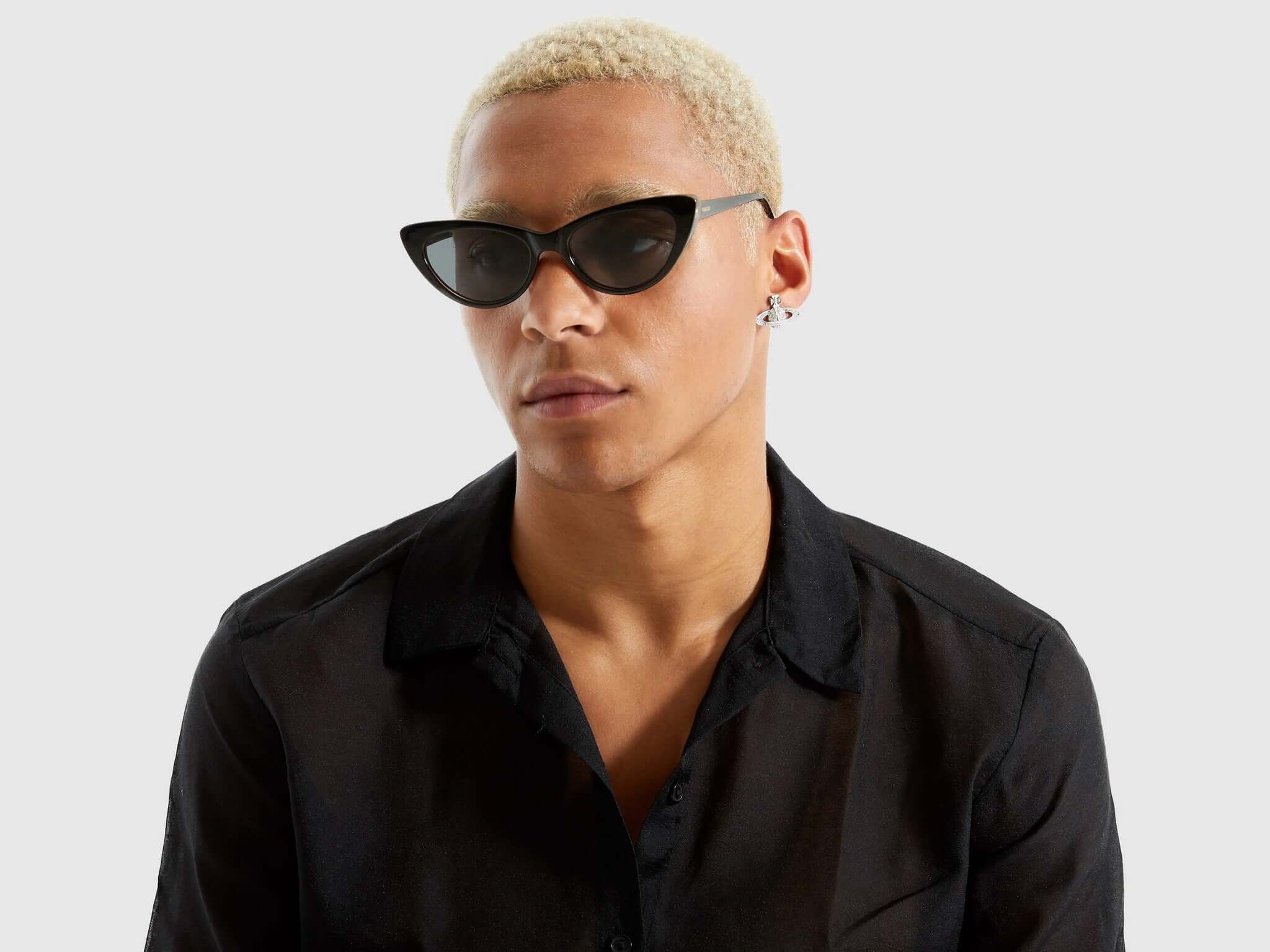 Model wearing Rosie Black Tortoise Sunglasses with a stylish black shirt and short blond hair.