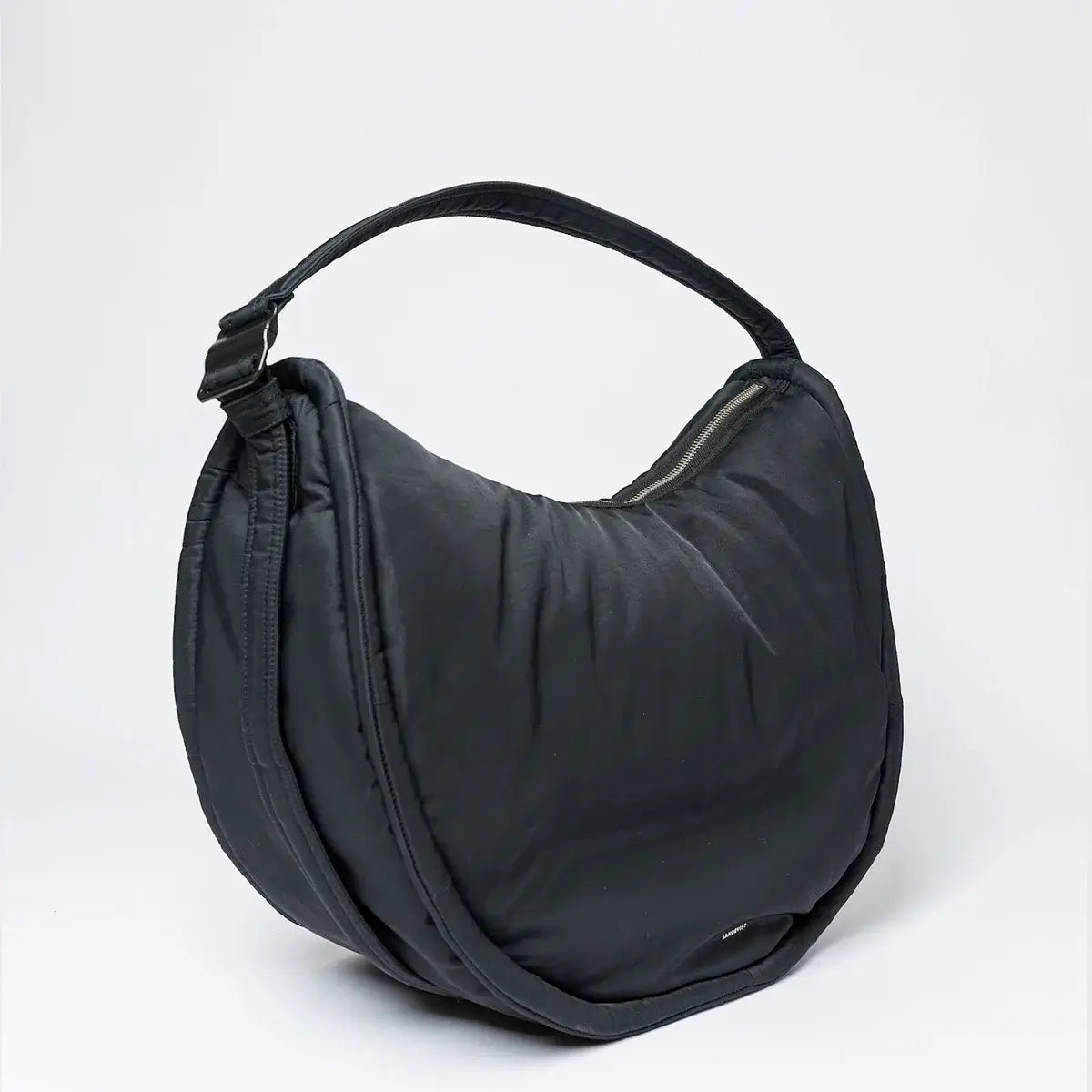 Curve Crossbody Round L Black Shoulder Bag, a water-resistant bag with a padded strap and internal zipper pocket.