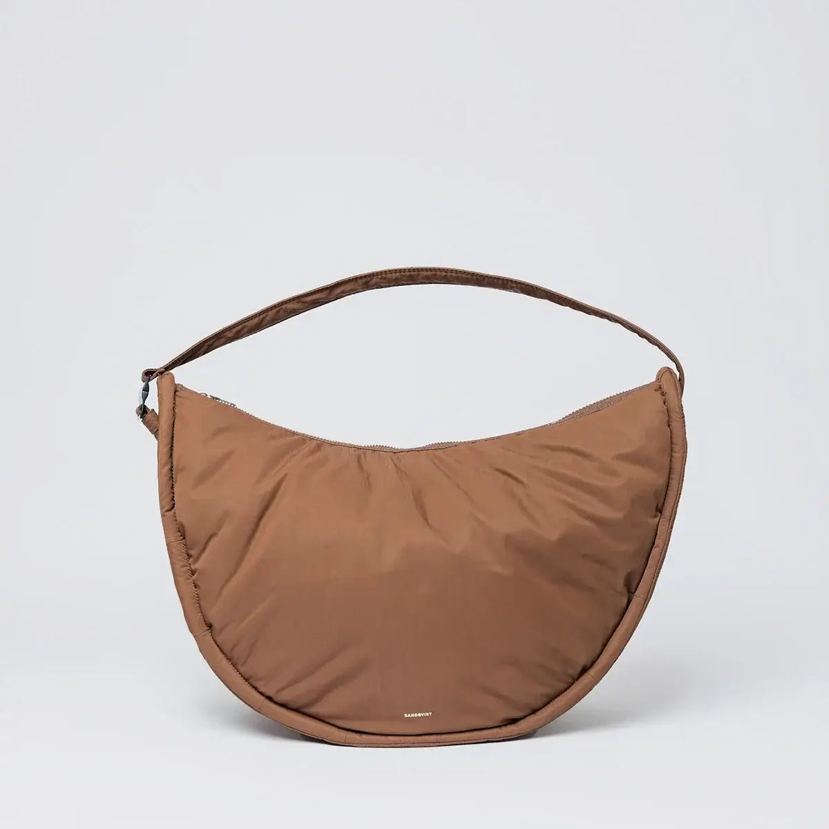 Curve Crossbody Round L Dark Taupe Shoulder Bag featuring a padded strap and water-resistant design.