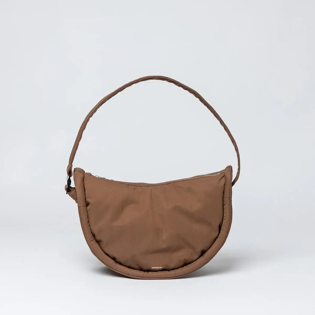 Curve Crossbody Round S Dark Taupe Shoulder Bag featuring a water resistant design and padded shoulder strap.