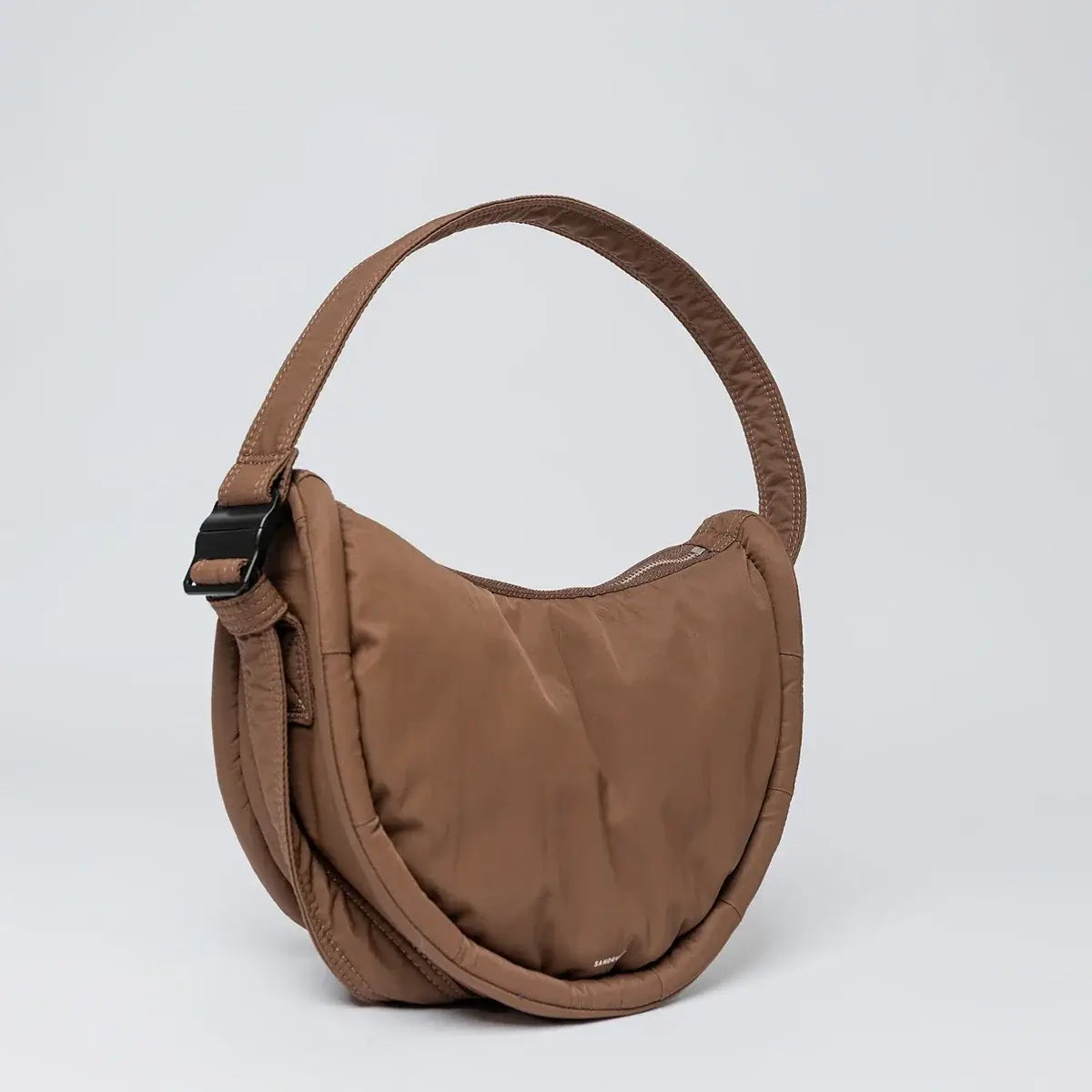 Curve Crossbody Round S Dark Taupe Shoulder Bag with padded strap and magnetic buckle, water resistant design.