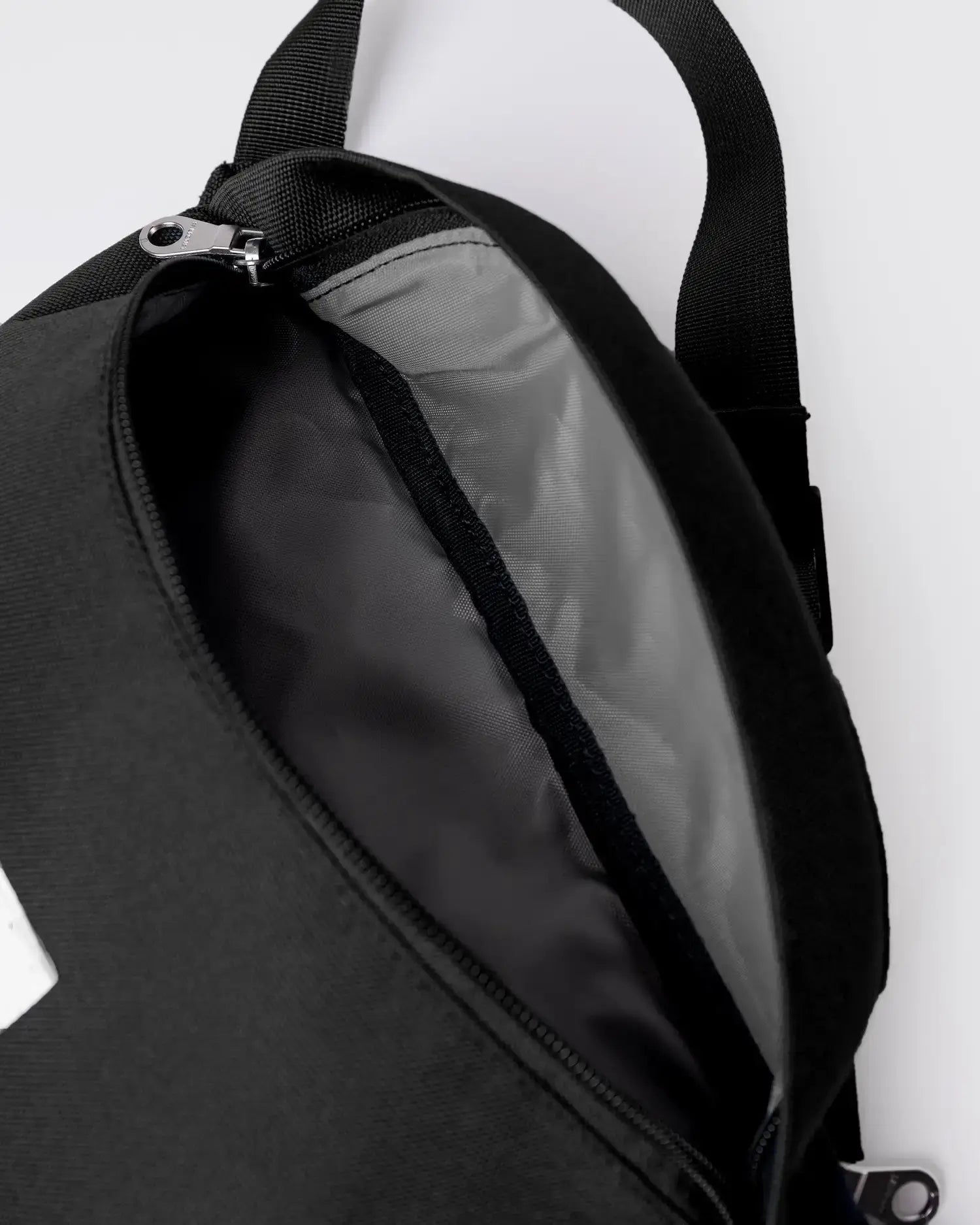 Inside view of the Ground Crossbody Bag Black Bum Bag showing the spacious interior and high-quality lining.
