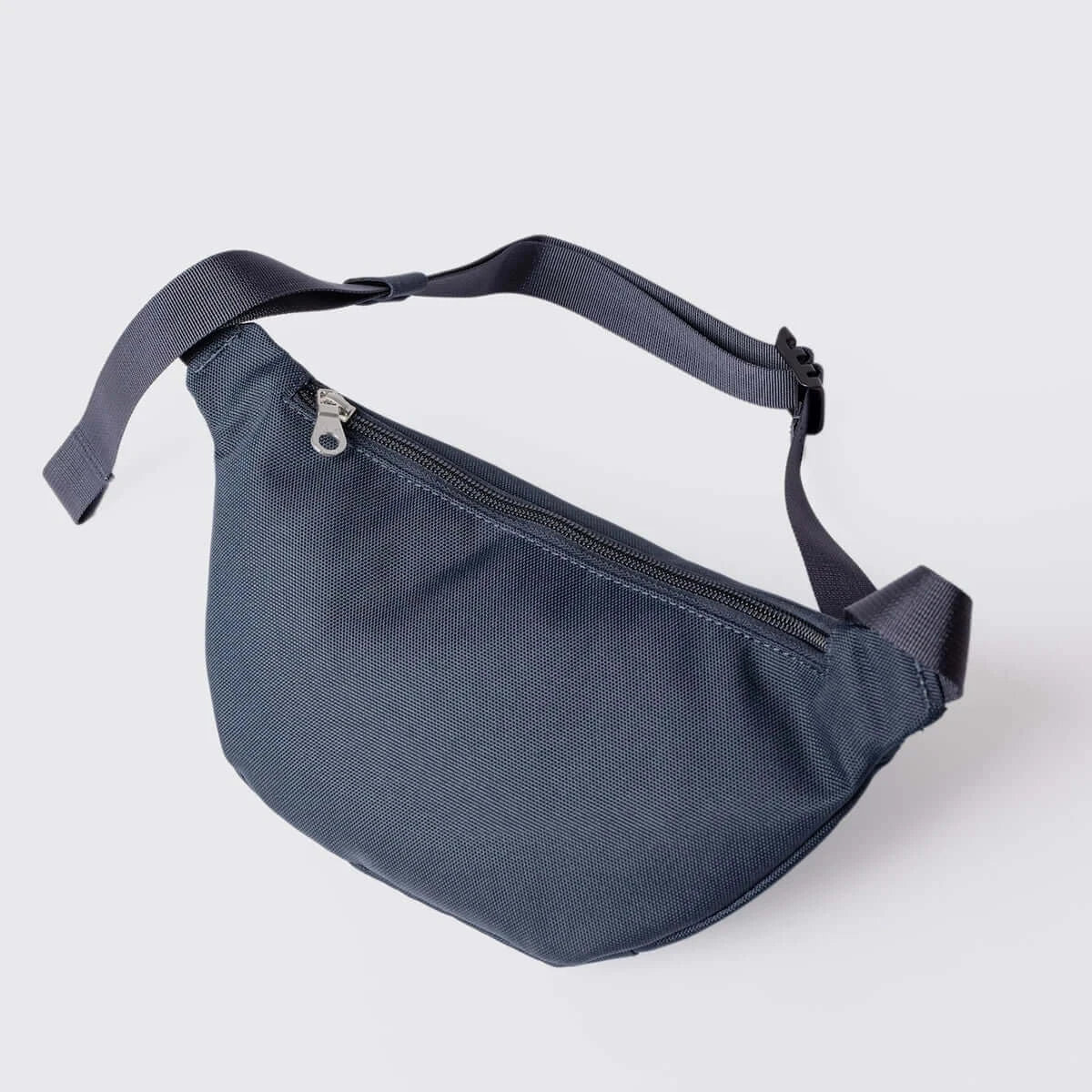Ground Crossbody Bag Navy Bum Bag with adjustable strap and extra zipped pocket for convenience.