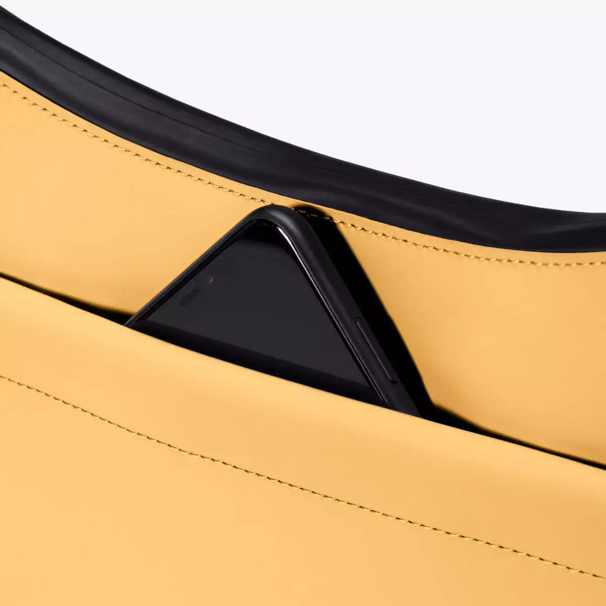 Alva Medium Lotus Infinity Lemon Shoulder Bag with a phone nestled in the front pocket.