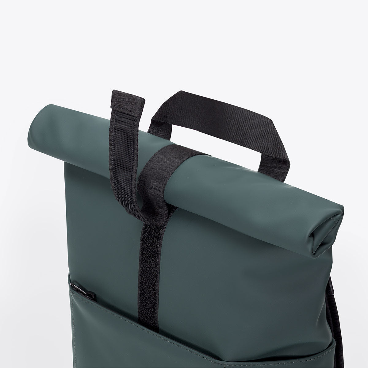 Hajo Mini Lotus Forest Backpack showing waterproof roll-top closure and velcro strap detail.