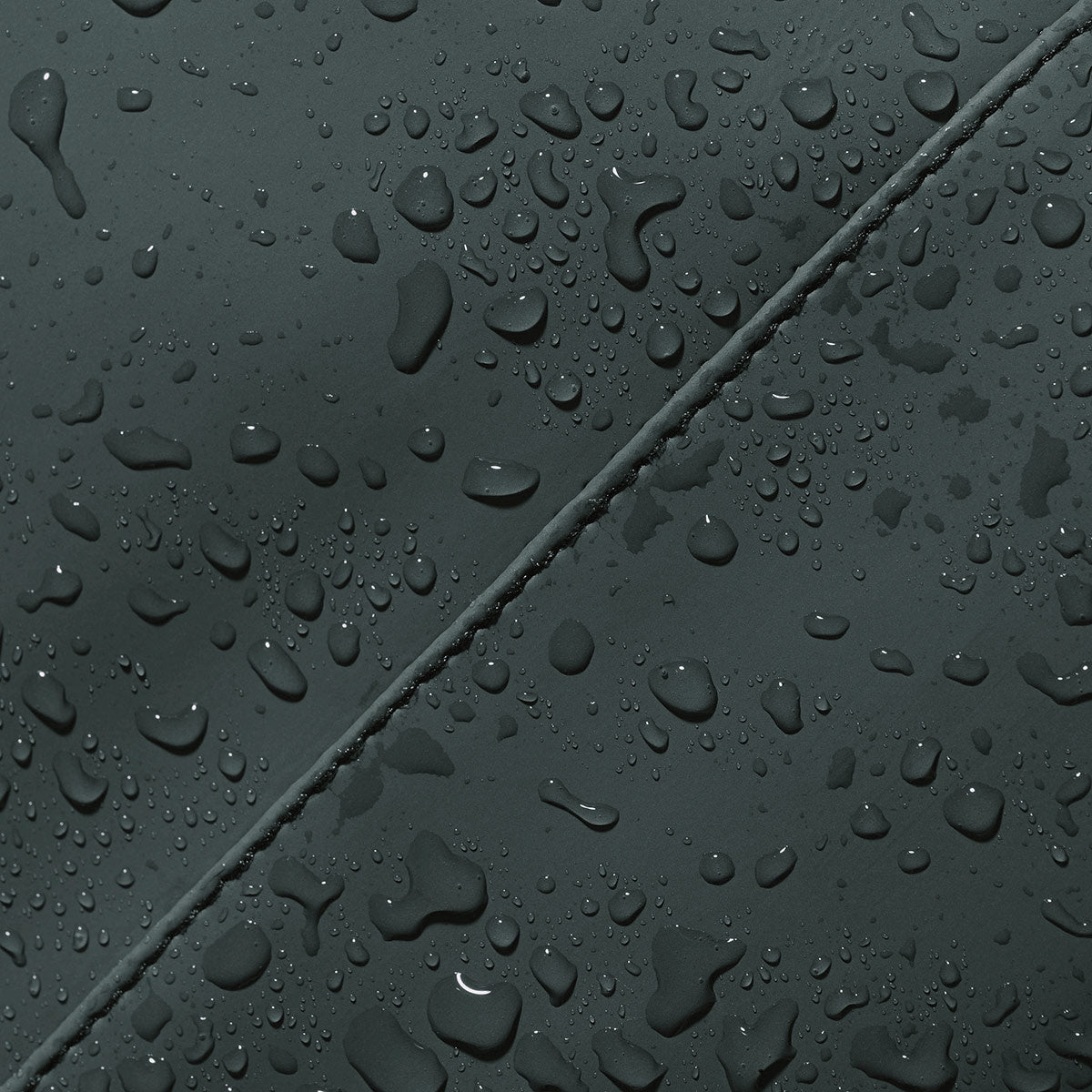 Close-up of water droplets on Hajo Mini Lotus Forest Backpack showcasing waterproof material.