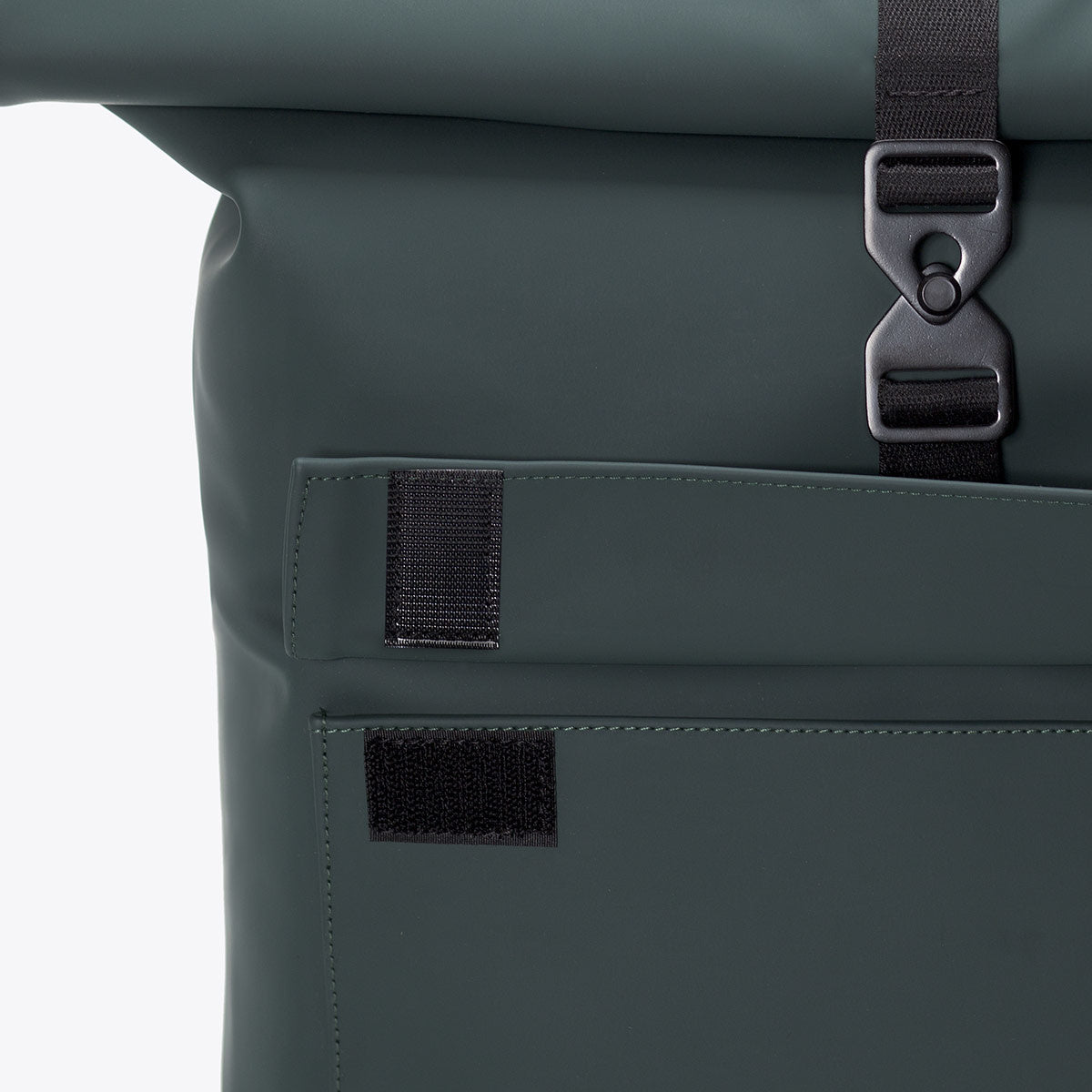Detail of the Jasper Lotus Forest Backpack showing roll-top closure and side pocket.
