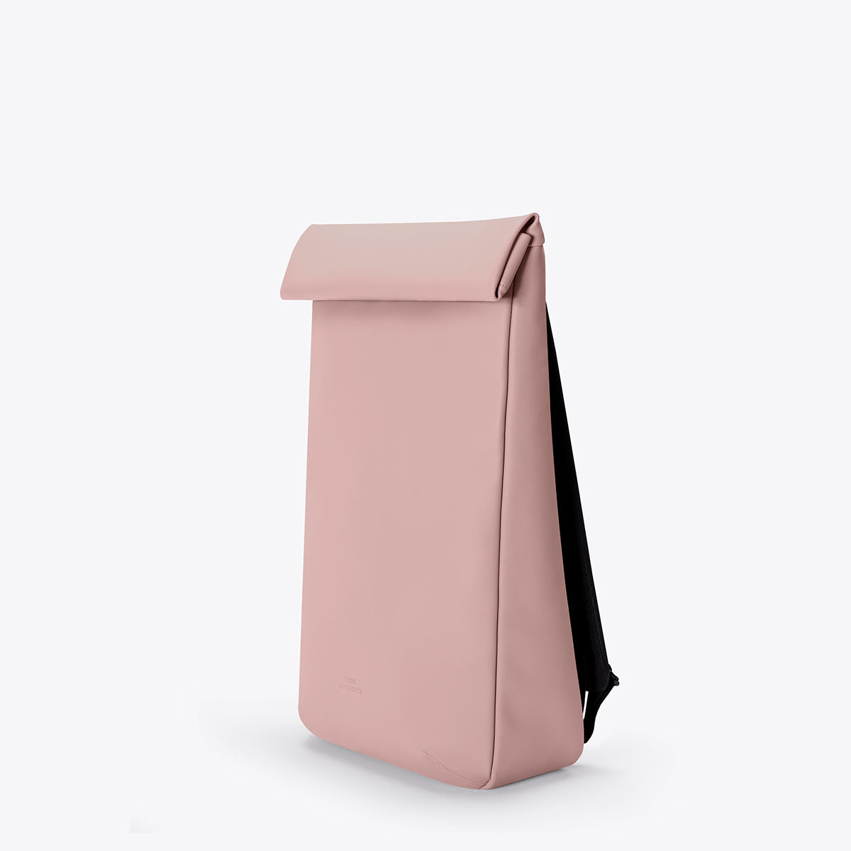 Kito Mini Lotus Rose Backpack in pink with roll-top closure and padded shoulder straps.