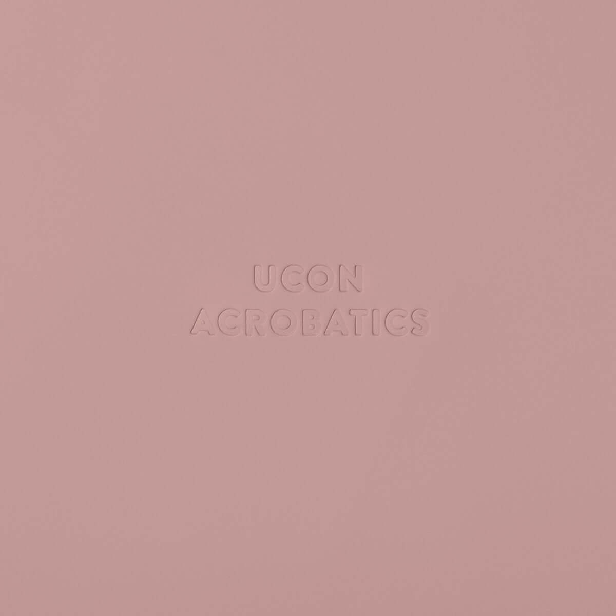 ucon acrobatics logo embossed on pink background