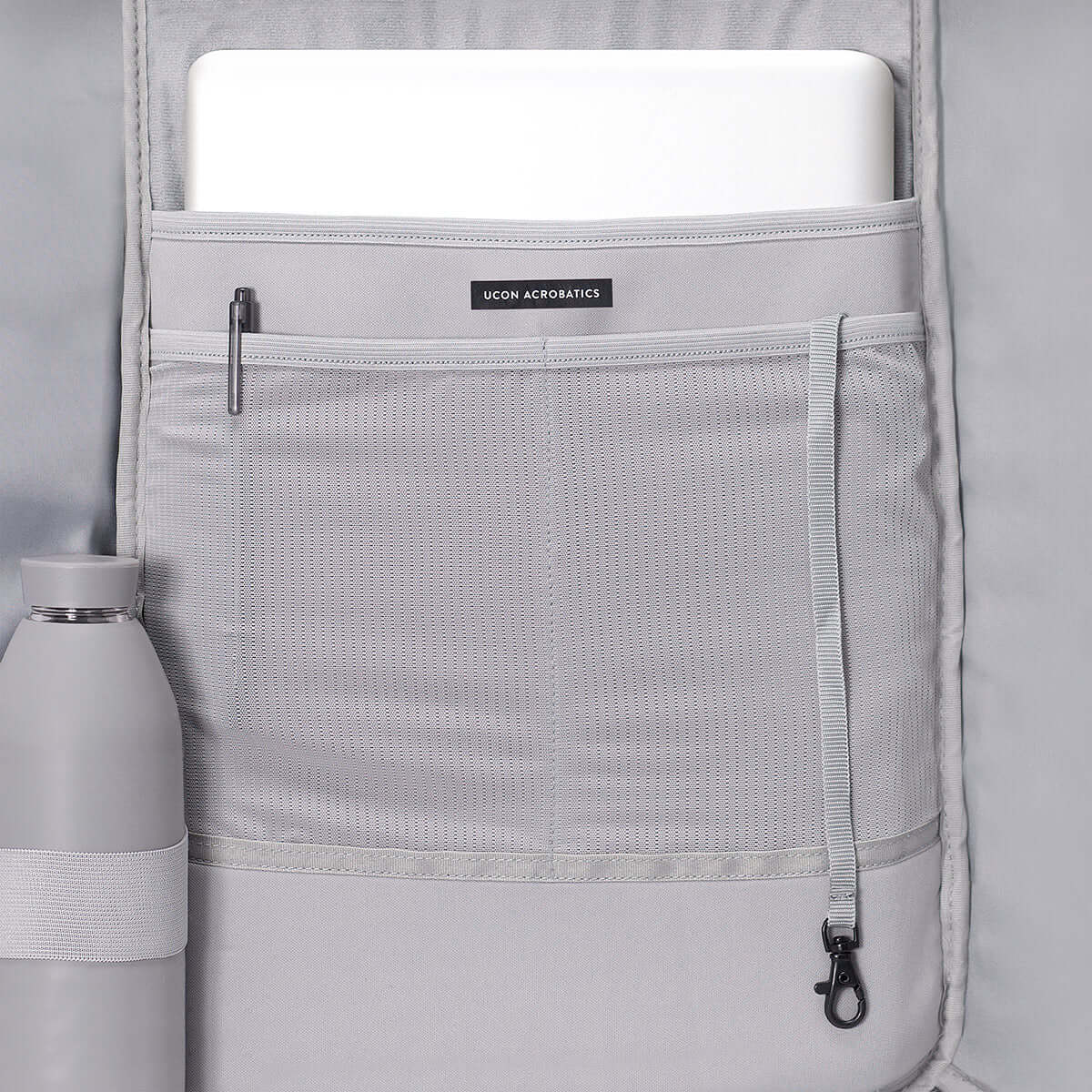 Kito Mini Lotus Rose Backpack interior showing padded laptop compartment and side pocket for water bottle.