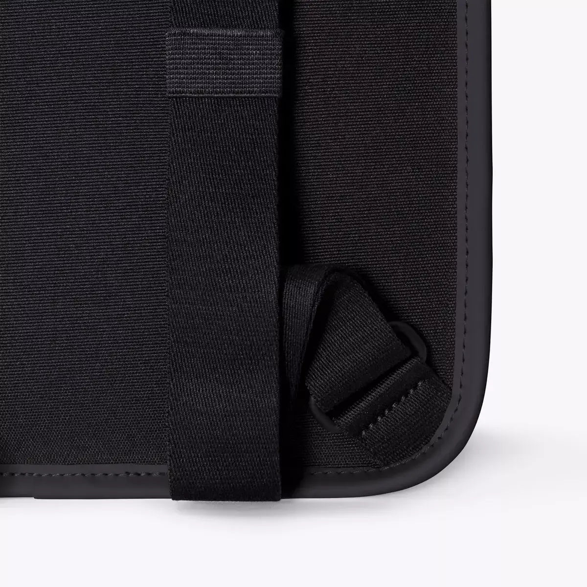 Close-up detail of the Adina Mini Lotus Infinity Black Backpack showing the strap and durable material.
