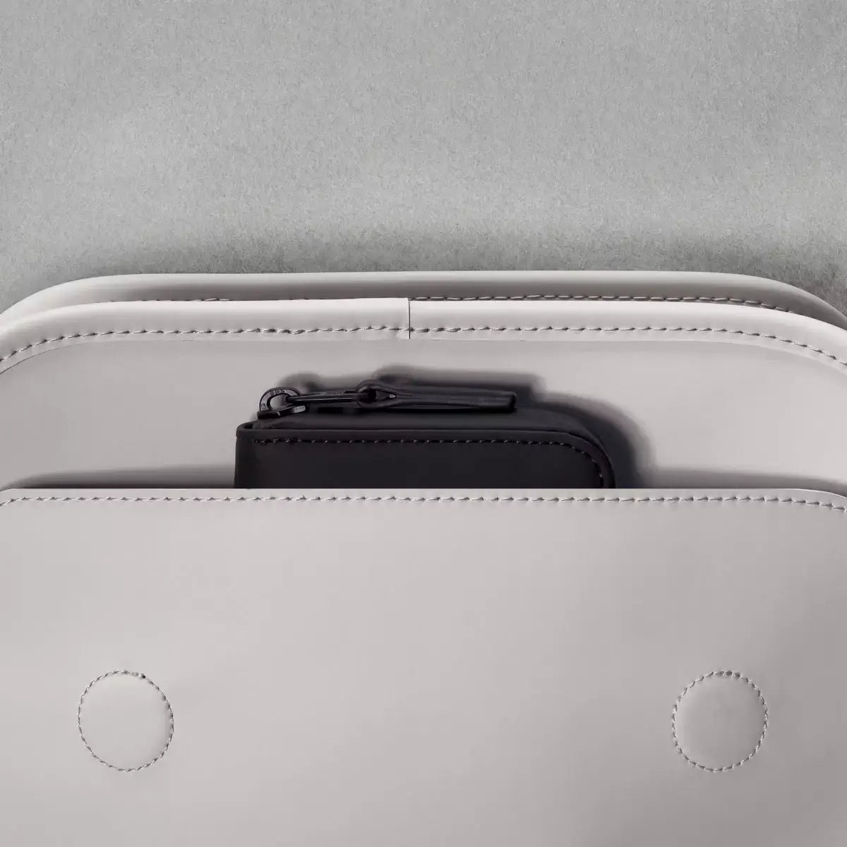 Close-up of Adina Mini Lotus Infinity Glacier Grey Backpack interior with hidden wallet pocket.