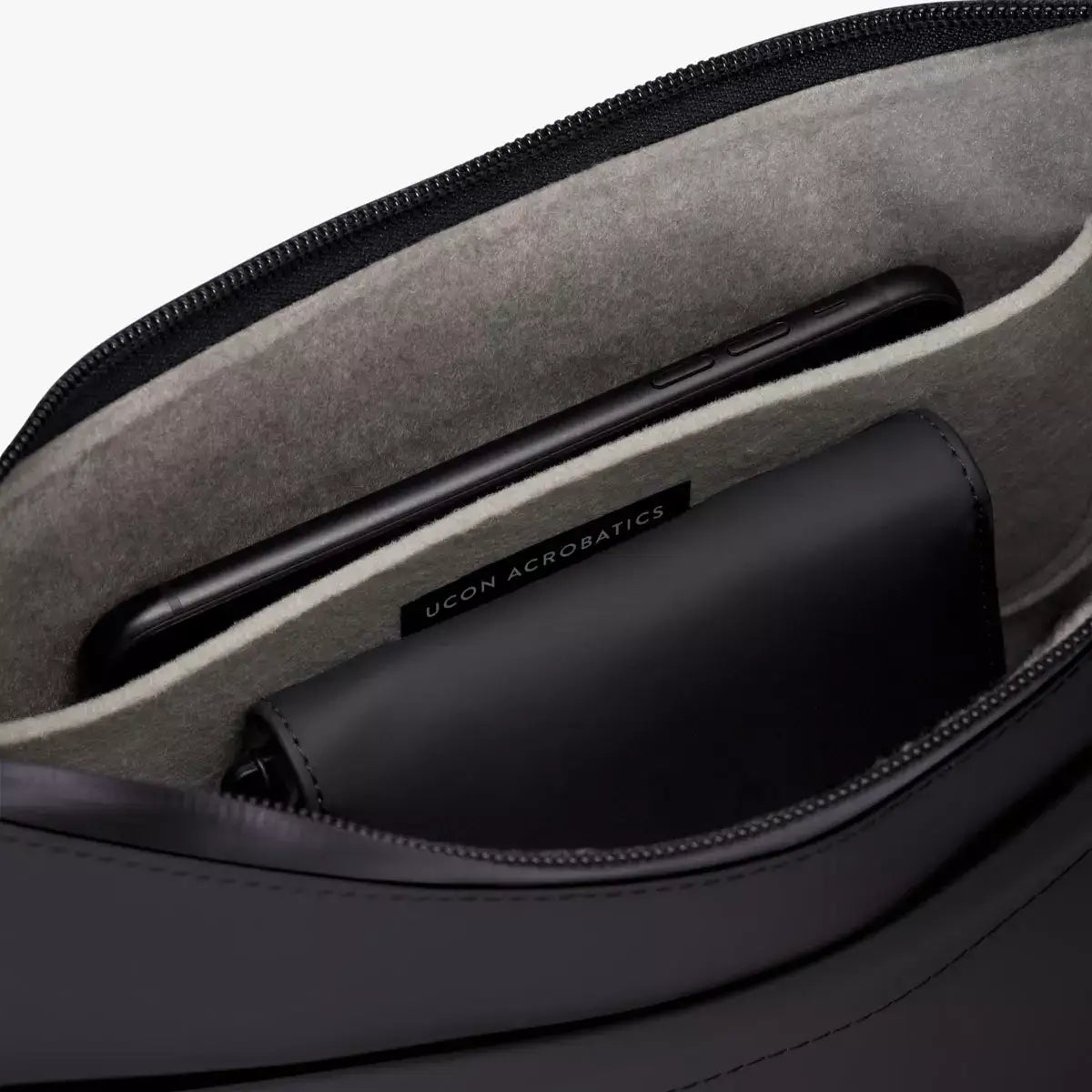 Inside view of Alva Medium Lotus Infinity Black Shoulder Bag showing soft felt interior and pockets.