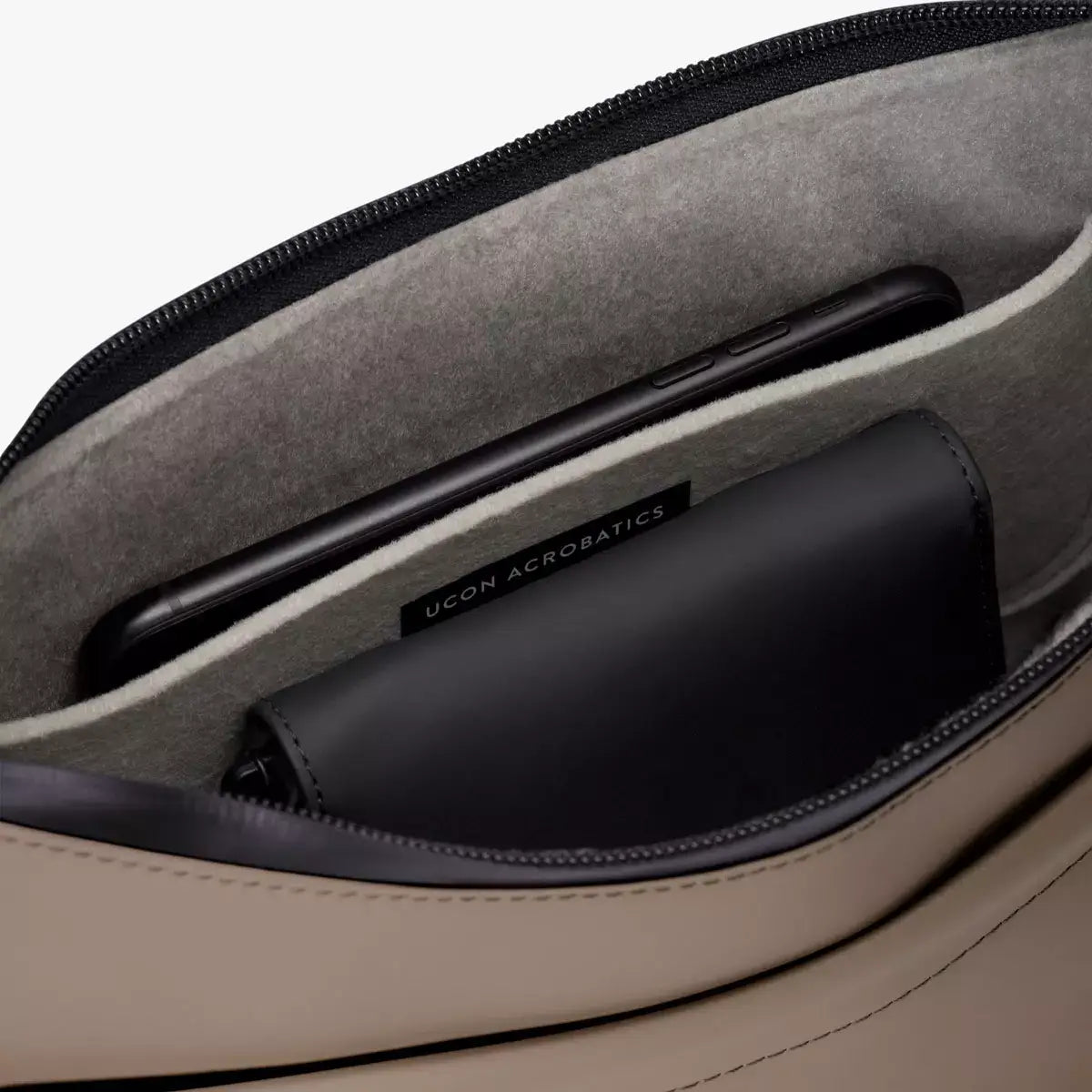 Inside view of Alva Medium Lotus Infinity Dark Sand Shoulder Bag with soft felt interior and pockets.
