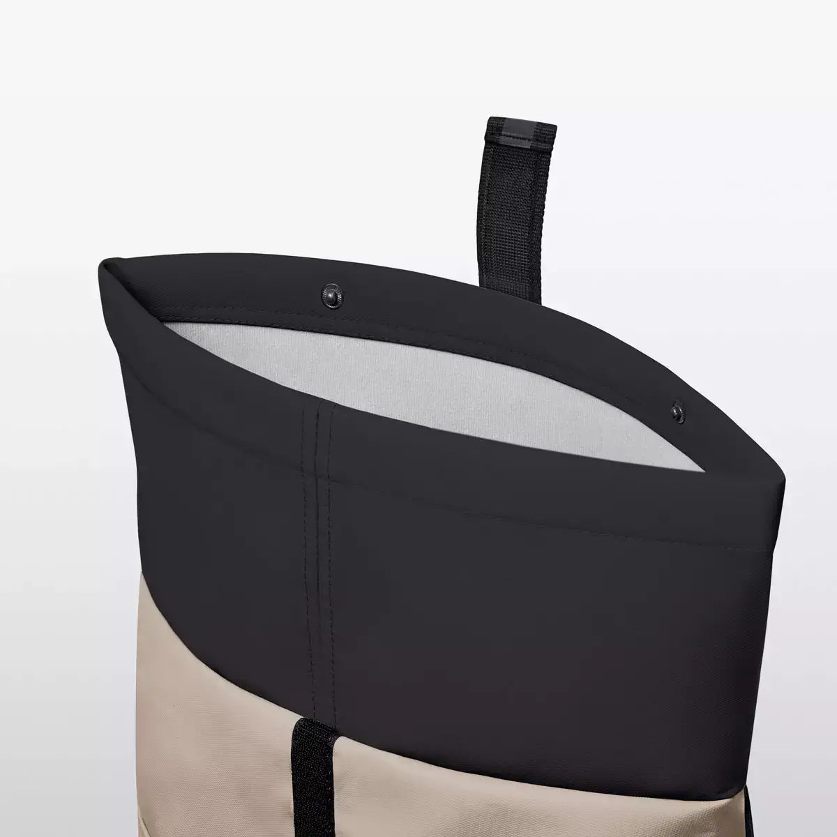 Interior view of Hajo Aloe Sand Black Backpack showing roll-top closure and interior design.