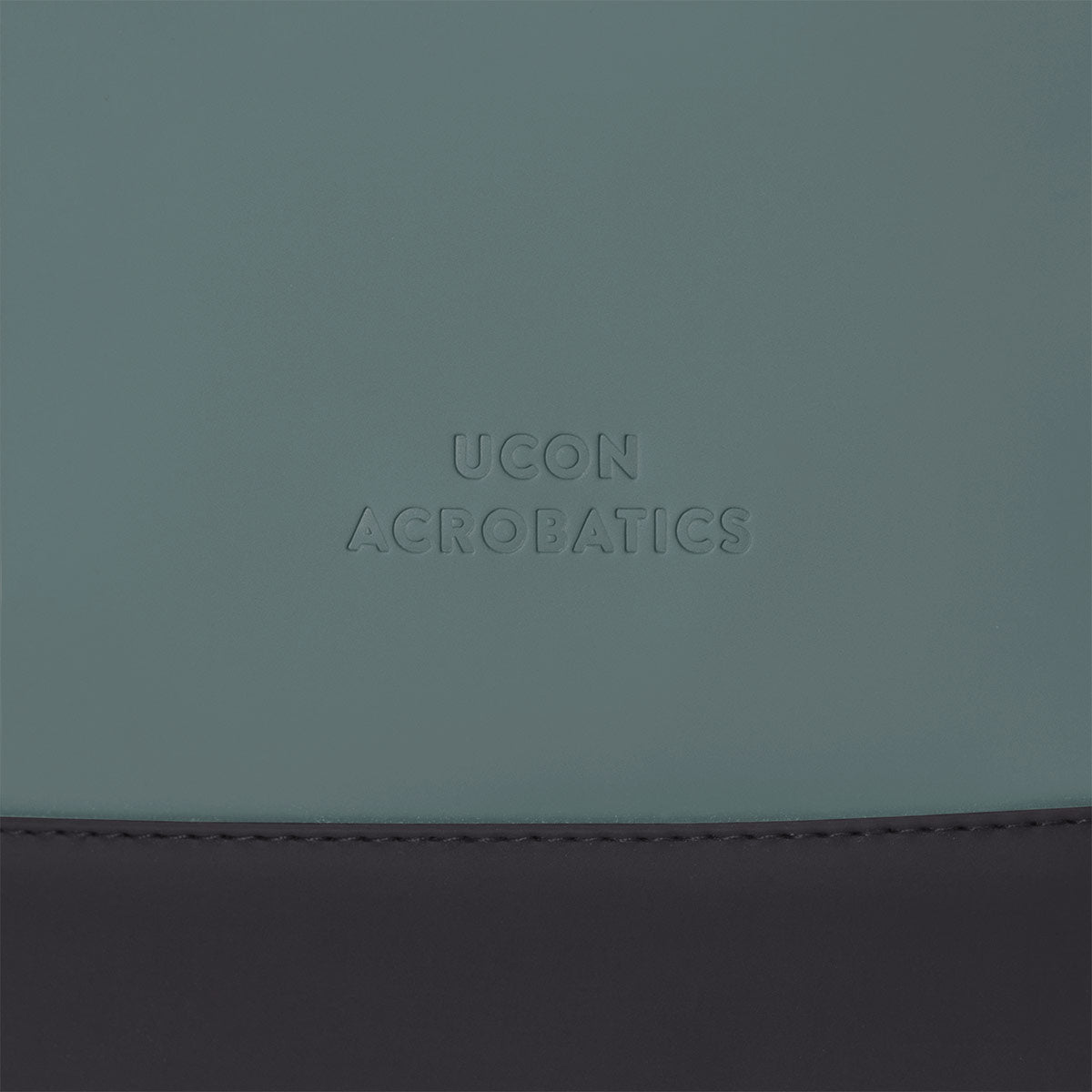 Hajo Lotus Forest Pine Green Backpack close-up view of UCON Acrobatics logo on the bag