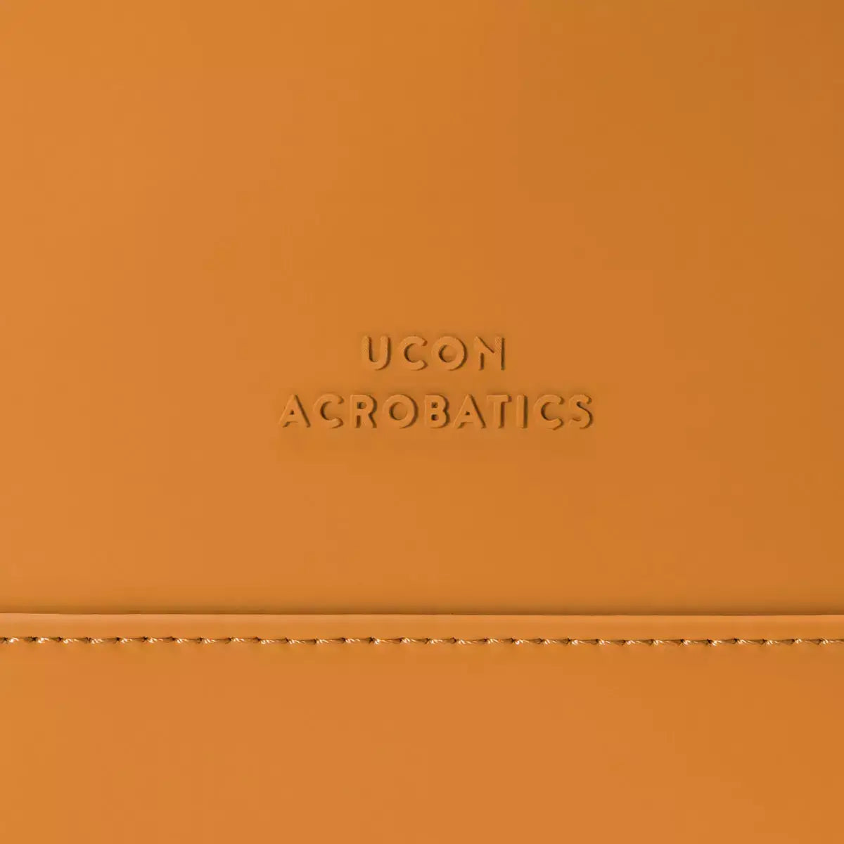 Hajo Lotus Infinity Honey Mustard Backpack showing UCON Acrobatics logo on orange material