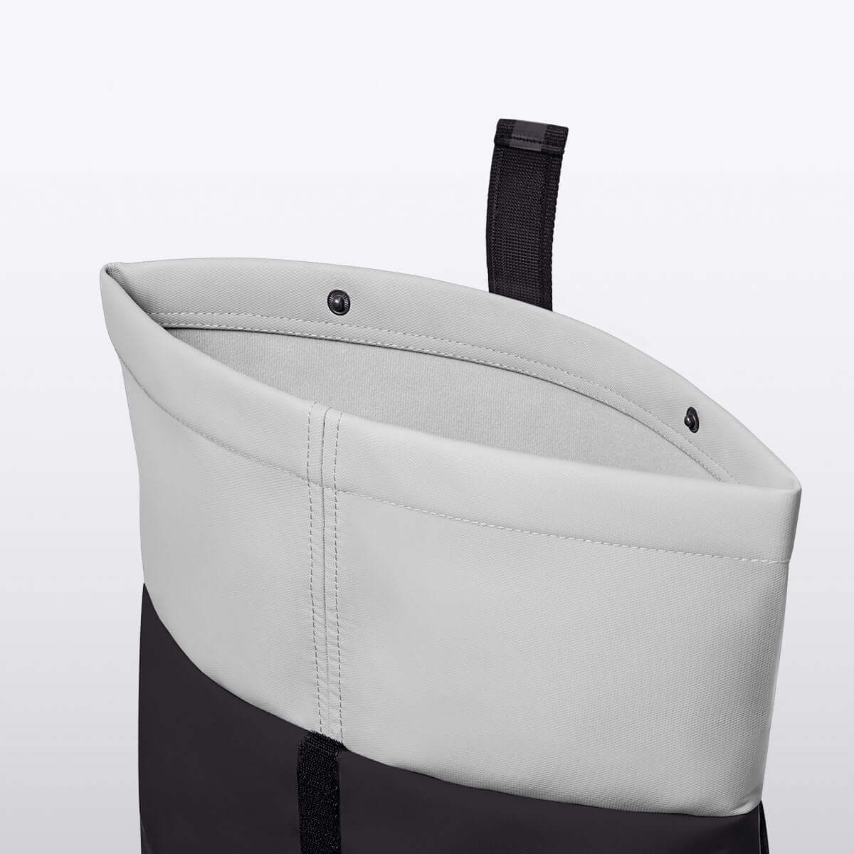 Inside view of Hajo Mini Aloe Black Backpack showing roll-top closure and waterproof materials.