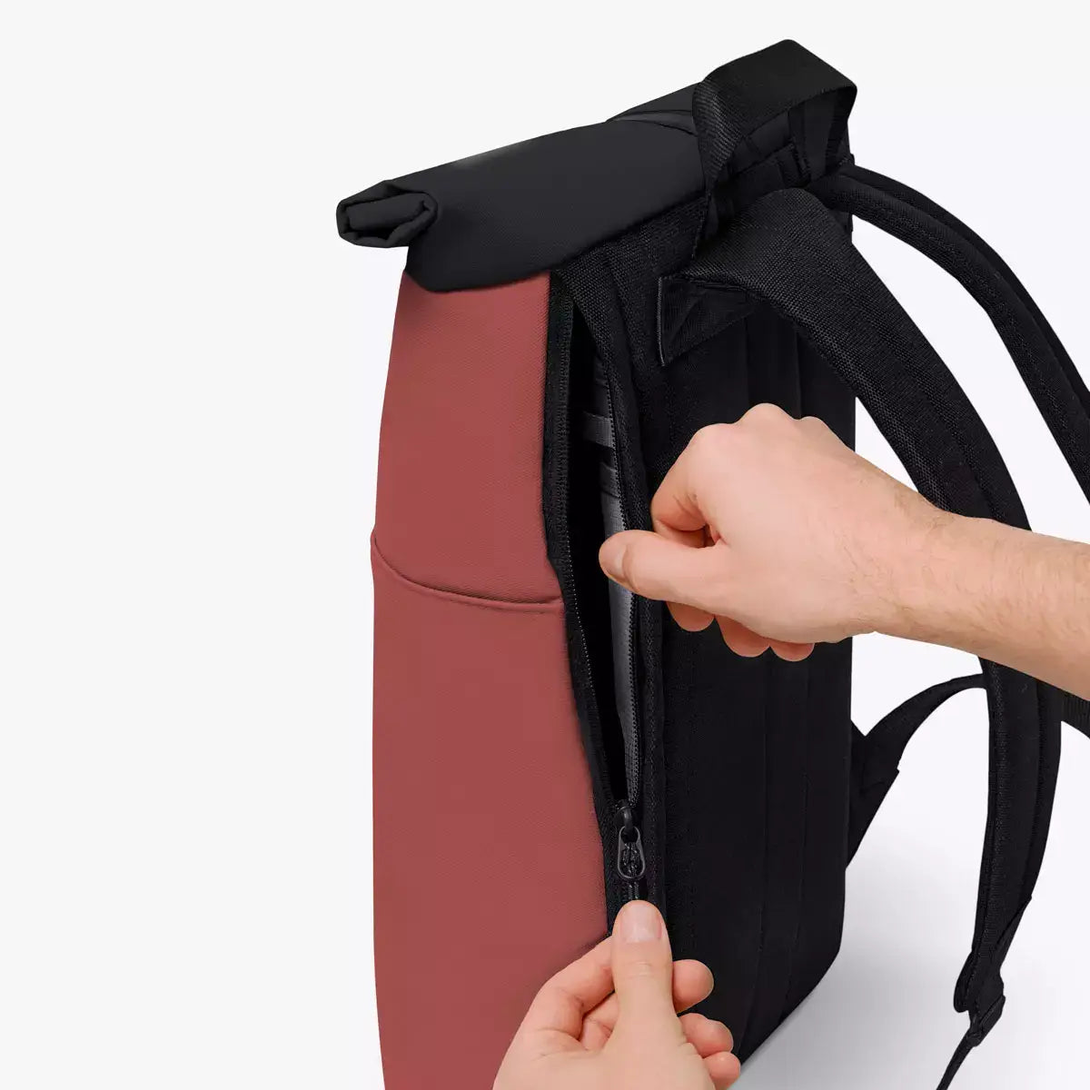 Hajo Mini Aloe Hibiscus Black Backpack side zipper detail with person using it.