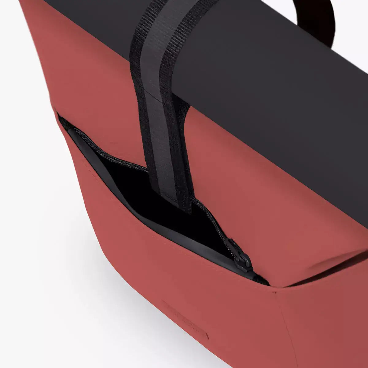 Hajo Mini Aloe Hibiscus Black Backpack showing the exterior pocket and roll-top design features.