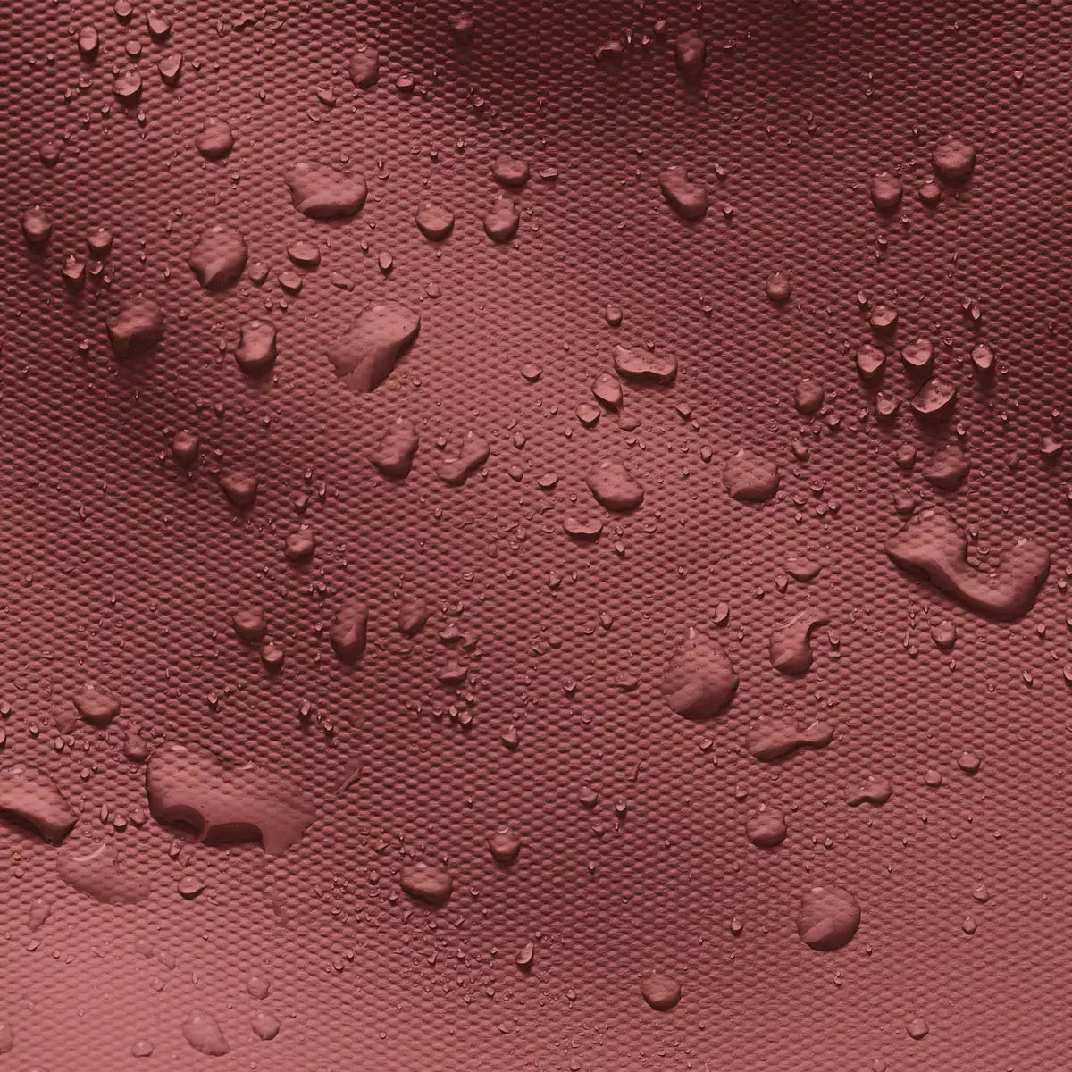 Waterproof and dirt repellent texture of the Hajo Mini Aloe Hibiscus Black Backpack fabric.