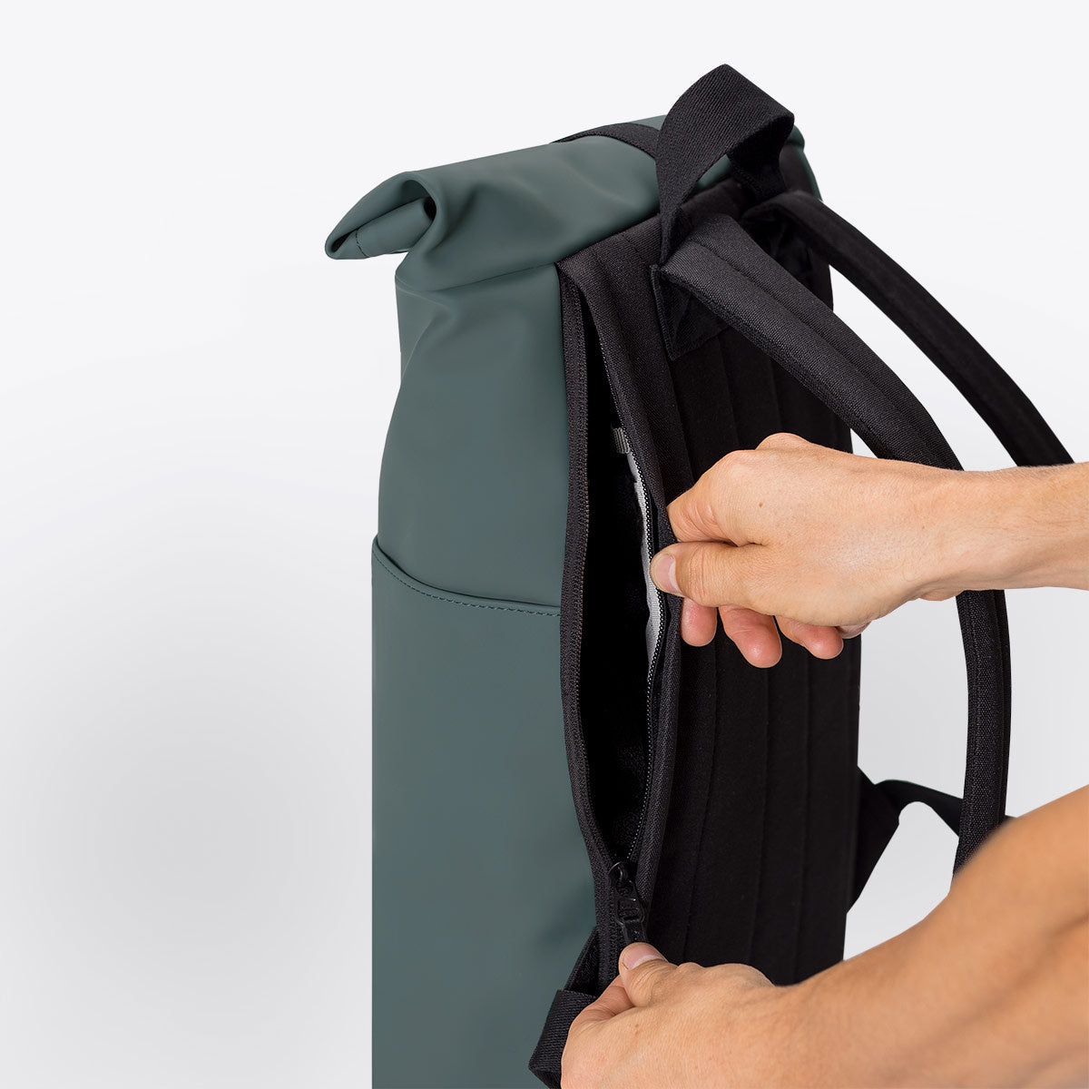 Hajo Mini Lotus Pine Green Backpack showcasing the roll-top closure and side zipper features.