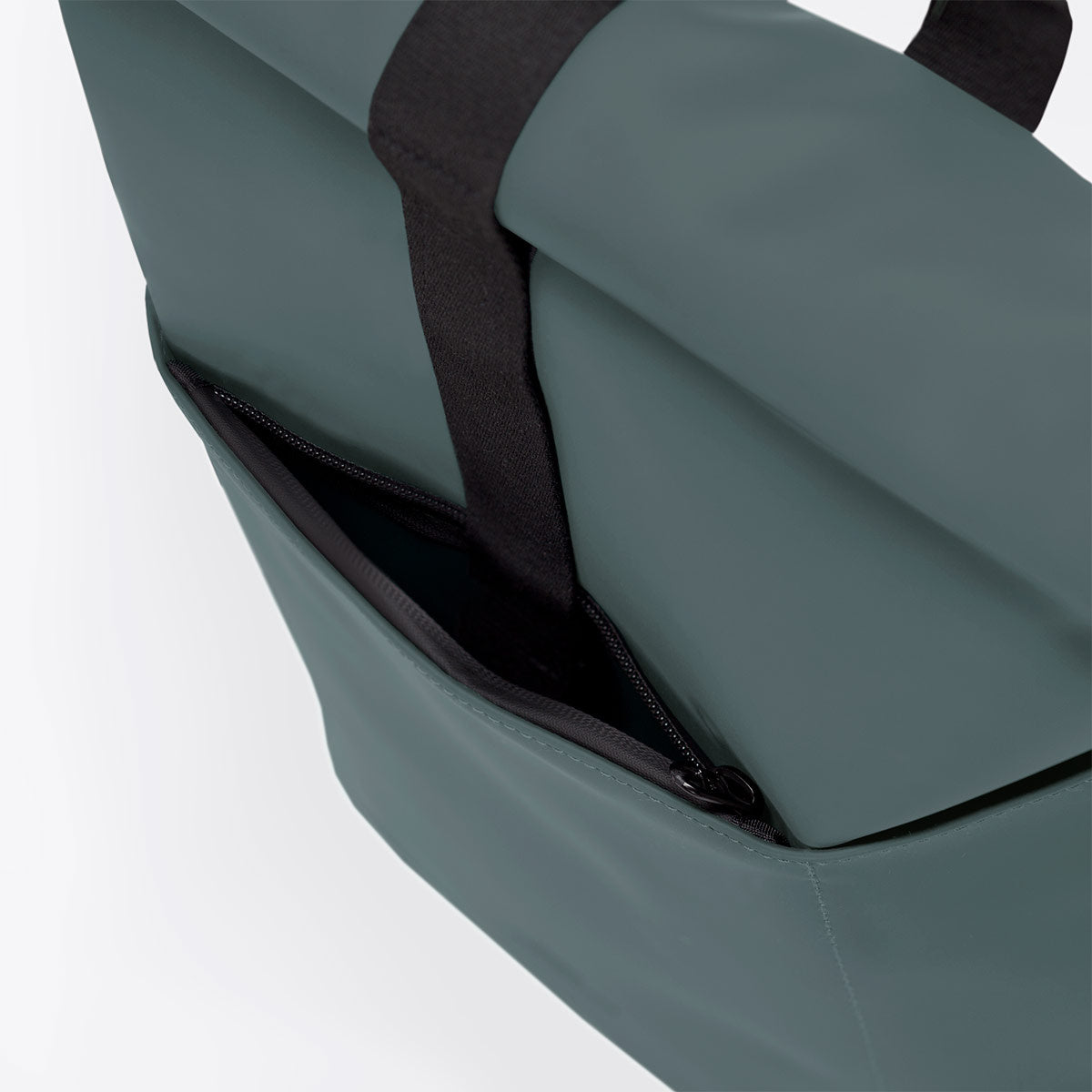Hajo Mini Lotus Pine Green Backpack showing waterproof material and side zipper pocket detail.