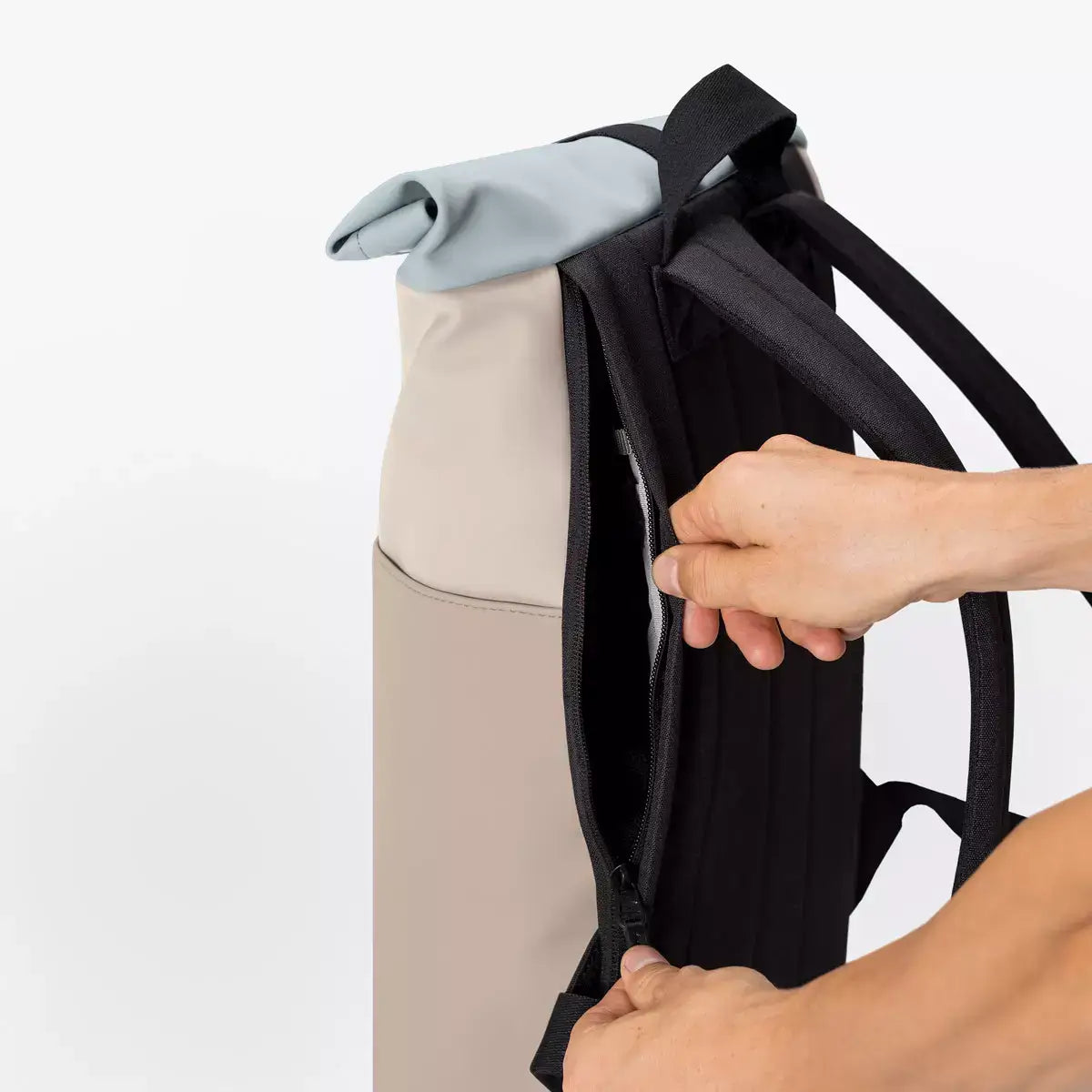 Hajo Mini Lotus Infinity Light Sand Sand Backpack showing waterproof side zipper and padded straps.