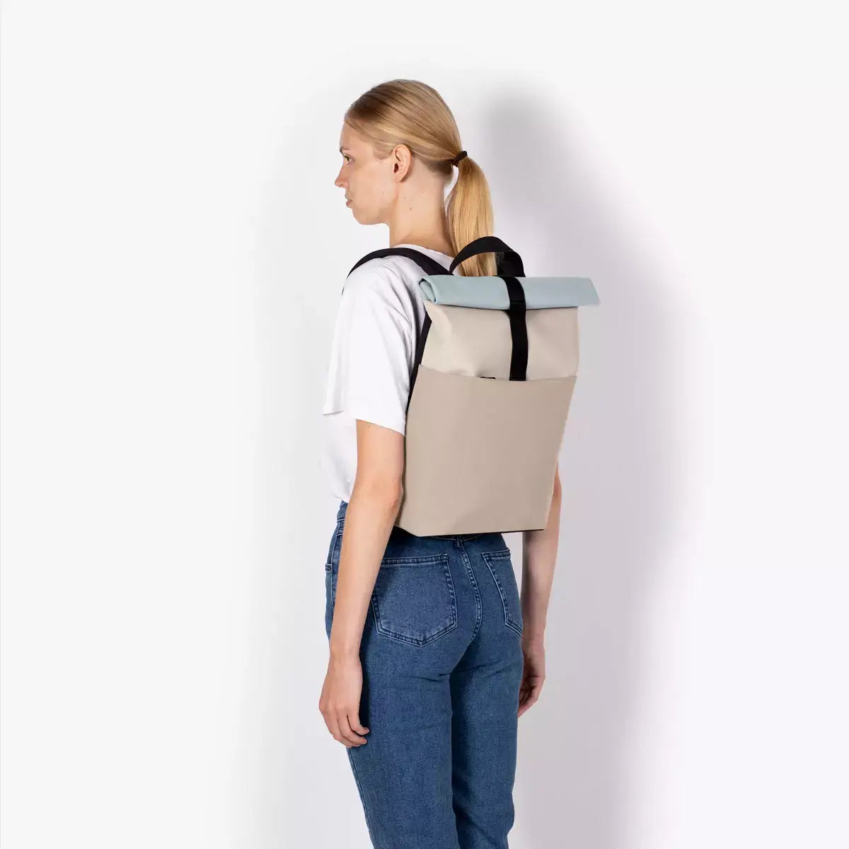 Hajo Mini Lotus Infinity Light Sand Sand Backpack worn by a woman, showcasing its stylish design and durable materials.
