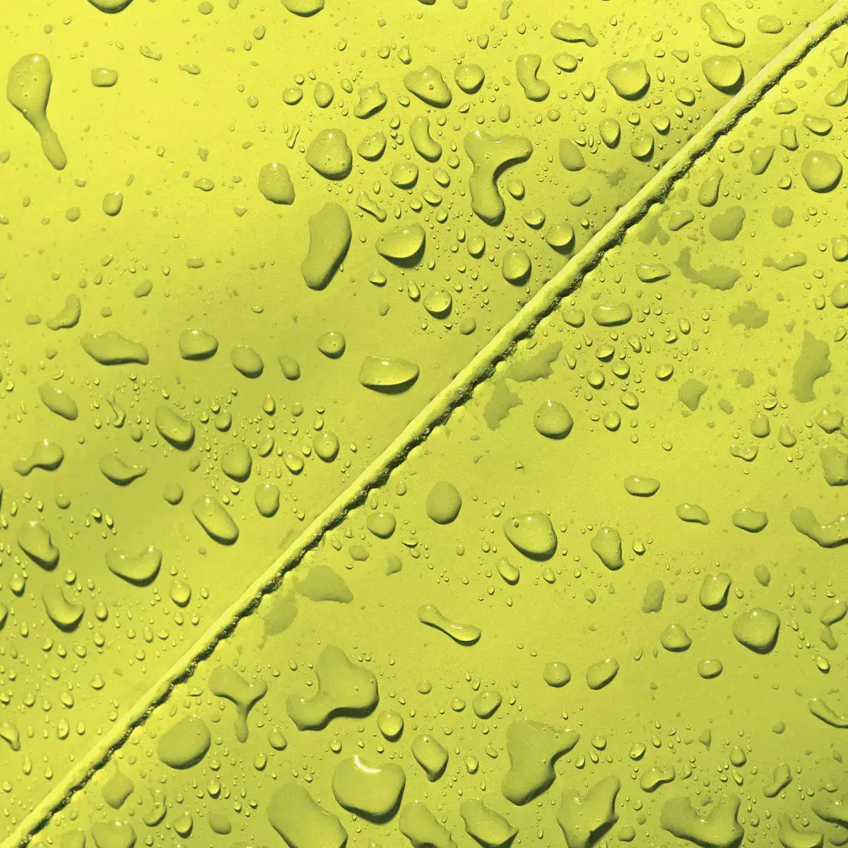 Close-up of waterproof fabric with water droplets showcasing Hajo Mini Lotus Acid Lime Backpack material.