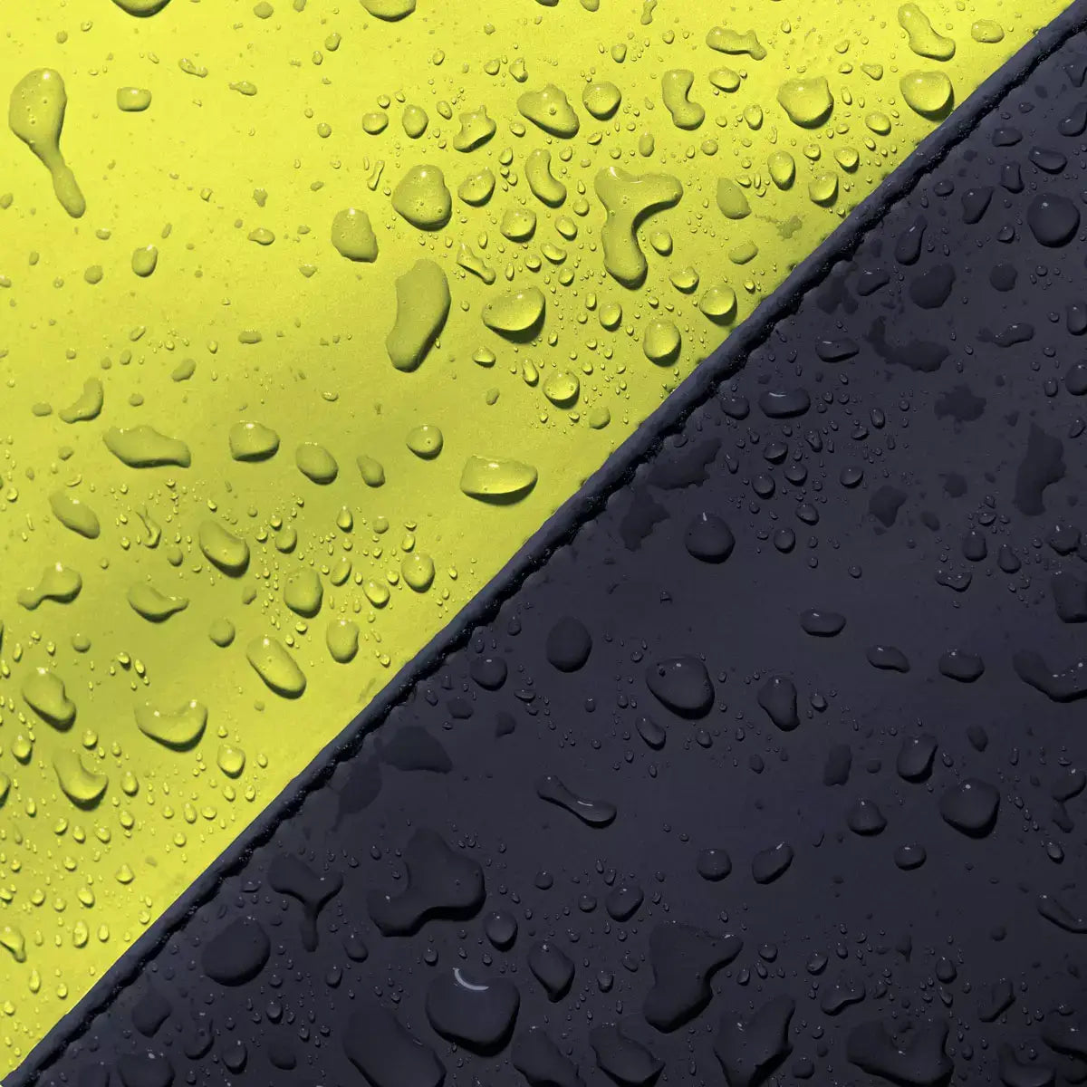 Waterproof surface showing raindrops on yellow and dark navy materials for Hajo Mini Lotus Dark Navy Light Grey Backpack.